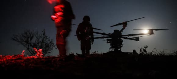 In this handout photograph taken on May 15, 2025 and released on May 16, 2025 by the press service of the 24th Mechanized Brigade of Ukrainian Armed Forces, Ukrainian servicemen prepare to fly a 'Kazhan' drone, designed to deliver cargo and carry heavy bombs, on the outskirts of Chasiv Yar, Donetsk region, amid the Russian invasion of Ukraine. (Photo by OLEG PETRASIUK / 24th Mechanized Brigade of Ukrainian Armed Forces / AFP) / RESTRICTED TO EDITORIAL USE - MANDATORY CREDIT