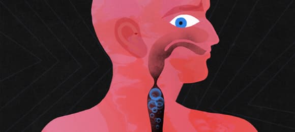 Czerwono-czarna grafika przedstawiająca przekrój przez przewód pokarmowy człowieka z gazami, które nie mogą się wydostać do góry