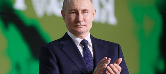 In this pool photograph distributed by Russian state agency Sputnik, Russia's President Vladimir Putin applauds during an event dedicated to the achievements of the All-Russian Public Movement 'People's Front' under the slogan 