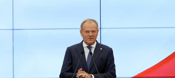 Donald Tusk przemawia za pulpitem