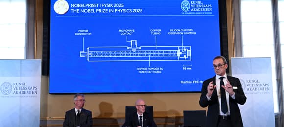 (L-R) Olle Eriksson, Chair of the Nobel Committee for Physics, and Hans Ellegren, Secretary General of The Royal Swedish Academy of Sciences, listen as Goeran Johansson, Member of the Nobel Committe for Physics, addresses a press conference on the awarding of the 2025 Nobel Prize in Physics to John Clarke (UK), Michel H. Devoret (France) and John M. Martinis (US) at the Royal Swedish Academy of Sciences in Stockholm, Sweden, on October 7, 2025. John Clarke (UK), Michel H. Devoret (France) and John M. Martinis (US) win the Nobel Prize in Physics 2025, 'for the discovery of macroscopic quatum mechanical tunnelling and energy quantisation in an electric circuit', it was announced on October 7, 2025. (Photo by Jonathan Nackstrand / AFP)