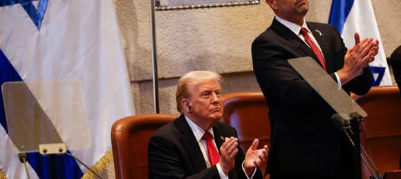 US President Donald Trump reacts during his address to the Israeli parliament, the Knesset, in Jerusalem on October 13, 2025. Hamas handed over the 20 surviving Israeli hostages on October 13 under a ceasefire agreement, as the US president and other world leaders geared up for a summit on Gaza. The releases are part of a ceasefire agreement brokered by the US president, with Israel due in return to free nearly 2,000 detainees held in its jails in exchange. (Photo by Jalaa MAREY / POOL / AFP)
