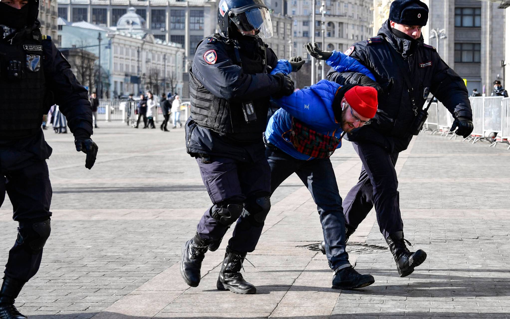 Police officers detain a man during a protest against Russian military action in Ukraine, in Manezhnaya Square in central Moscow on March 13, 2022. (Photo by - / AFP)