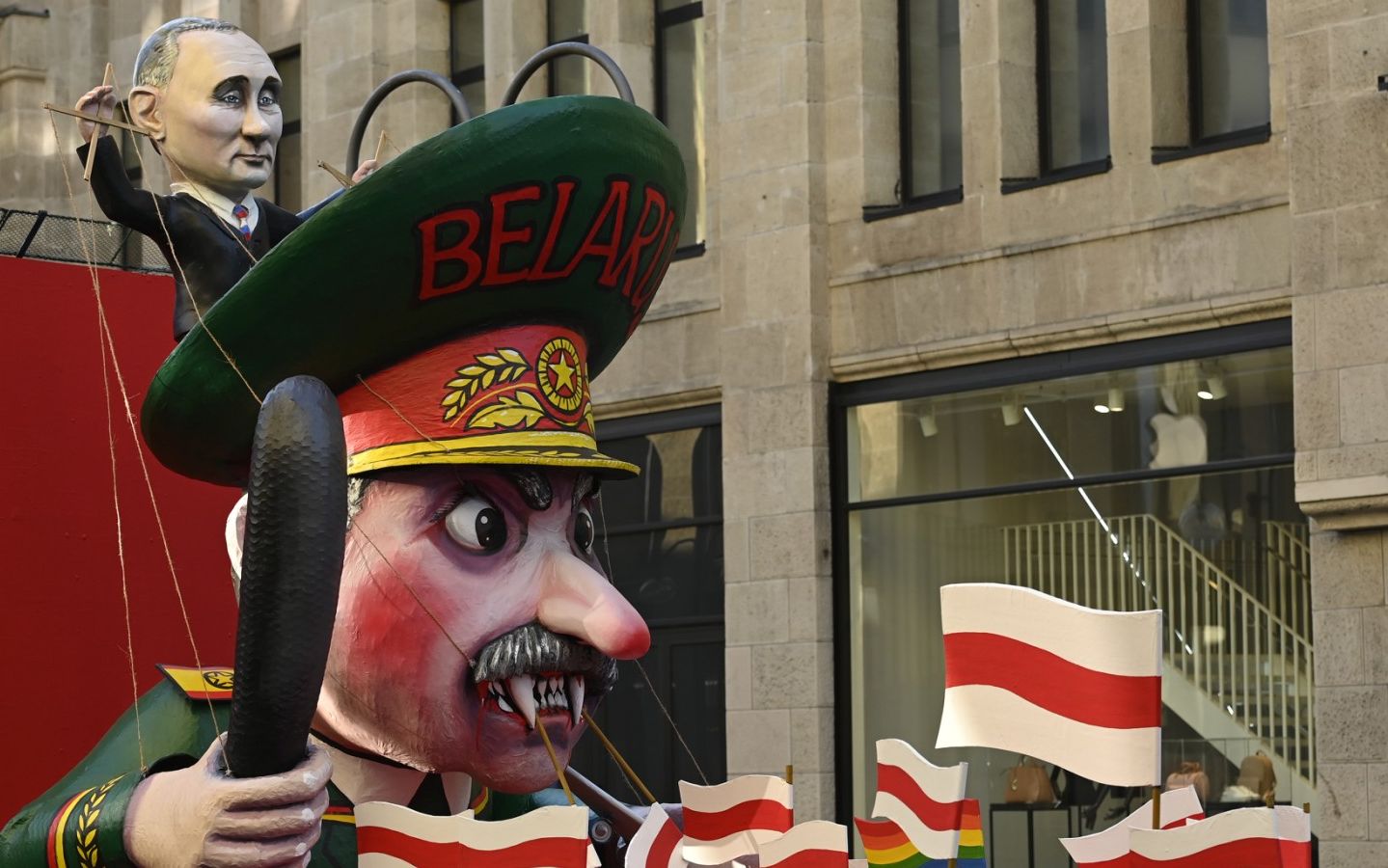 A carnival float featuring Russian President Vladimir Putin (top) handling Belarus' President Alexander Lukashenko like a puppet, is presented in the center of Cologne, western Germany, on February 28, 2022, where a "Freedom for Ukraine" demonstration will be instead of the traditional carnival Rose Monday procession. (Photo by Ina Fassbender / AFP)