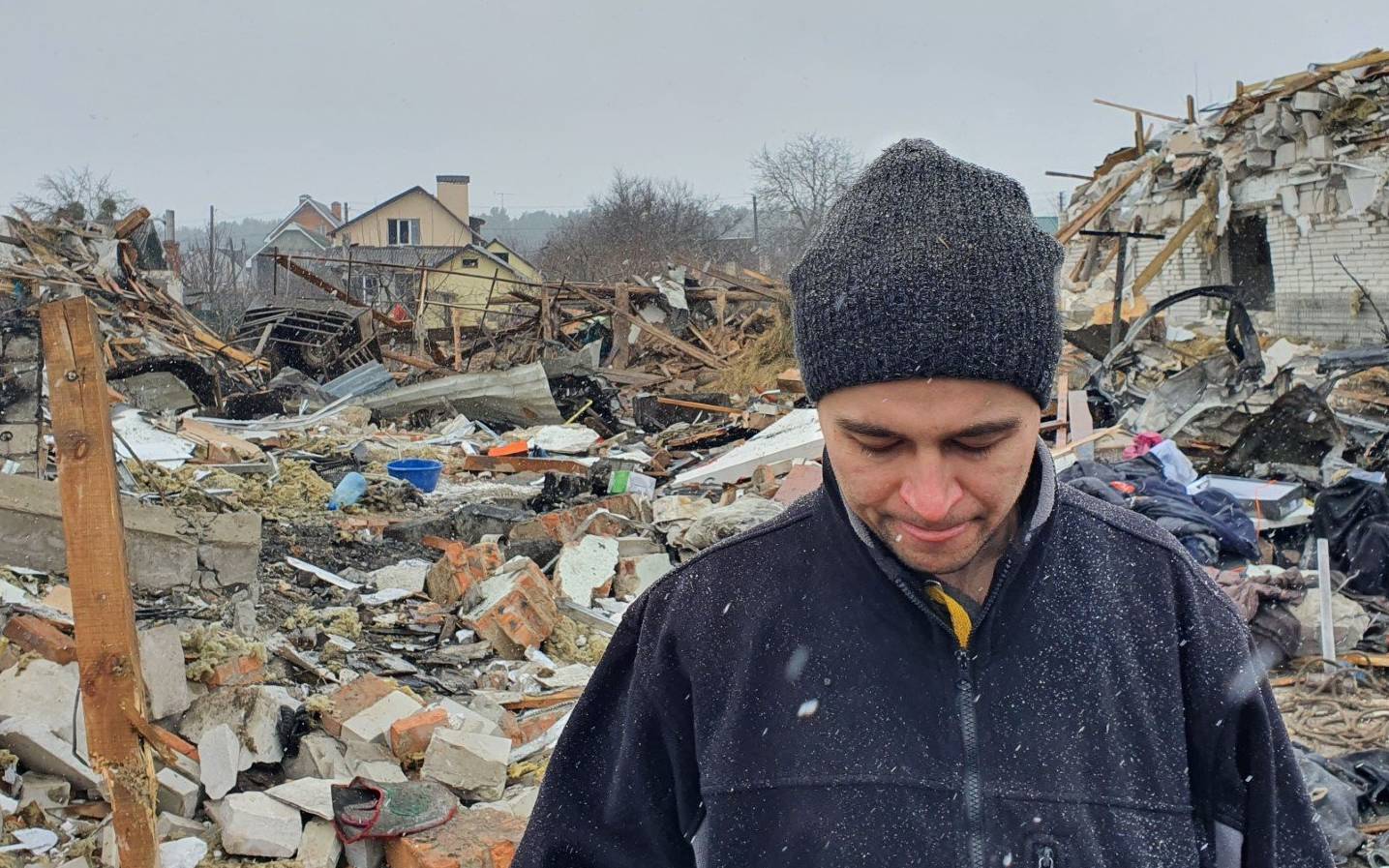 Oleg Rubak, 32, a local engineer who lost his wife Katia, 29, in the shelling, stands on the rubble of his house in Zhytomyr on March 02, 2022, after it was destroyed by a Russian bombing the day before. - The shelling killed at least 3 people and injured nearly 20 according to locals and local authorities, destroyed a local market and at least 10 houses on March 01, 2022. (Photo by Emmanuel DUPARCQ / AFP)