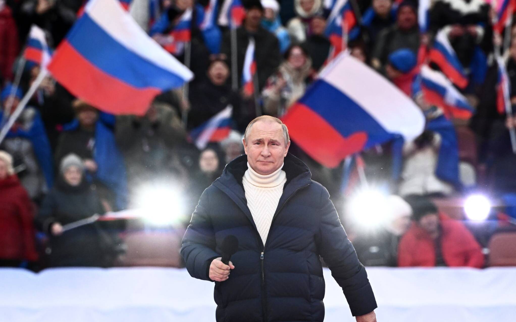 Russian President Vladimir Putin attends a concert marking the eighth anniversary of Russia's annexation of Crimea at the Luzhniki stadium in Moscow on March 18, 2022. (Photo by Sergei GUNEYEV / POOL / AFP)