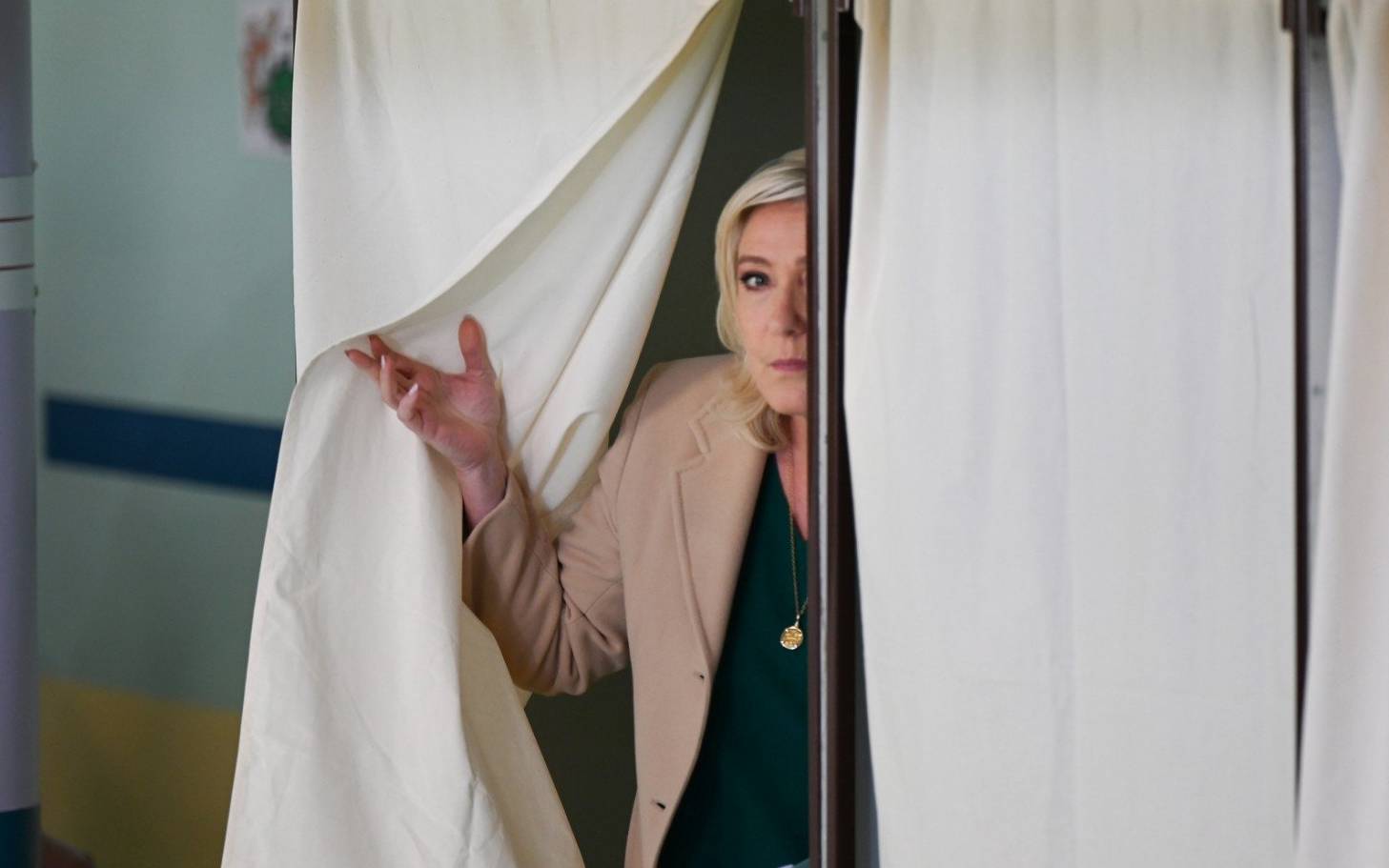 French far-right party Rassemblement National (RN) presidential candidate Marine Le Pen leaves the polling booth as she votes during the first round of France's presidential election at a polling station in Henin-Beaumont, northern France on April 10, 2022. (Photo by Denis Charlet / AFP)