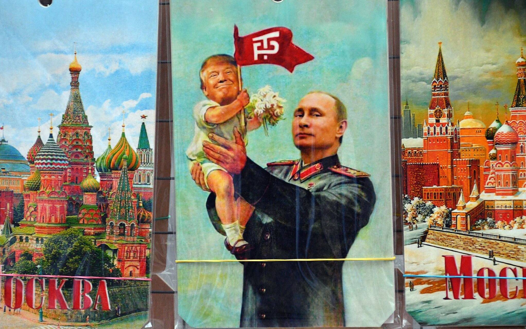 A picture taken on July 5, 2017 shows a souvenir kiosk offering among others a drawing depicting Russian President Vladimir Putin holding a baby with the face of US President Donald Trump, based upon a propaganda poster showing late soviet leader Joseph Stalin holding a baby, in Moscow. - It was a constant refrain on the campaign trail for Donald Trump in his quest for the US presidency: "We're going to have a great relationship with Putin and Russia."
Now, weighed down by claims that Moscow helped put him in the White House, Trump is set to finally meet his Russian counterpart in an encounter fraught with potential danger for the struggling American leader. (Photo by Mladen ANTONOV / AFP)