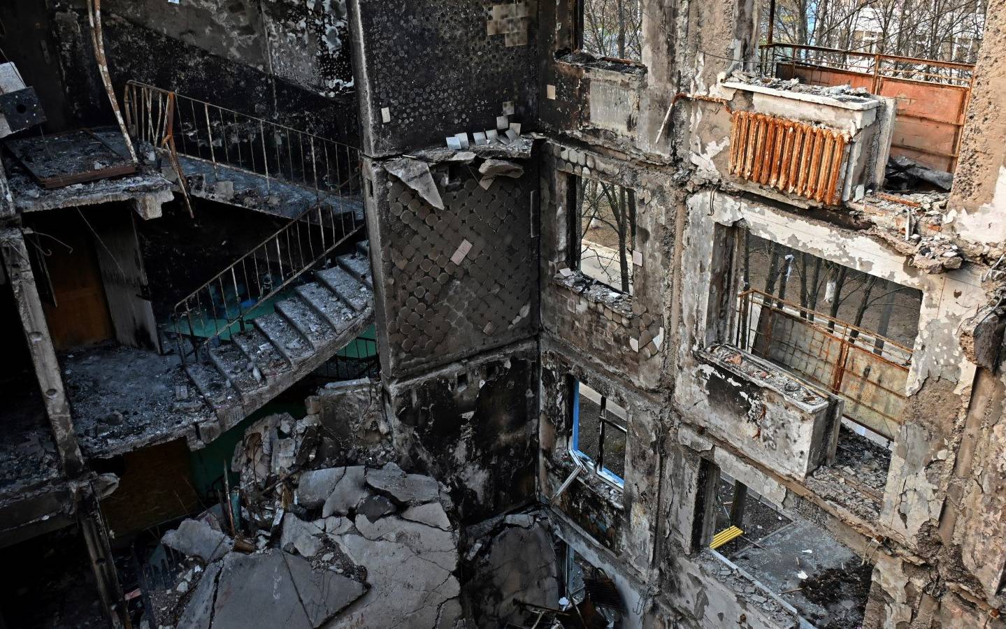 This photograph shows a partially destroyed five storey residential building in the Ukrainian city of Kharkiv, on April 10, 2022, amid the Russian invasion of Ukraine. (Photo by SERGEY BOBOK / AFP)