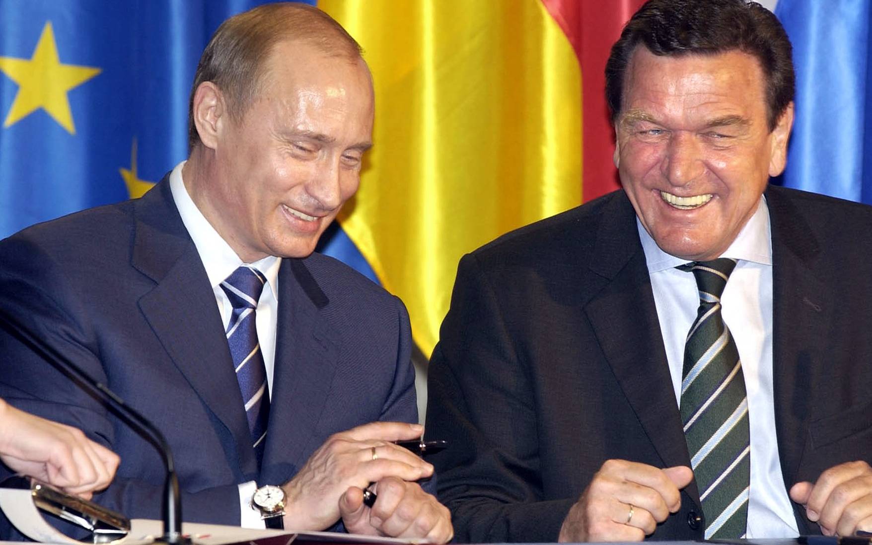 German Chancellor Gerhard Schroeder (R) and Russian President Vladimir Putin smile during a signing ceremony in Hanover, 11 April 2005. Vladimir Putin tried to reassure jittery foreign investors that his government had no plans to reverse controversial privatisations during the opening of the Hannover fair, one of the world's biggest trade fairs. AFP PHOTO / ITAR-TASS / PRESIDENTIAL PRESS SERVICE




. (Photo by SERGEI ZHUKOV / TASS / AFP)