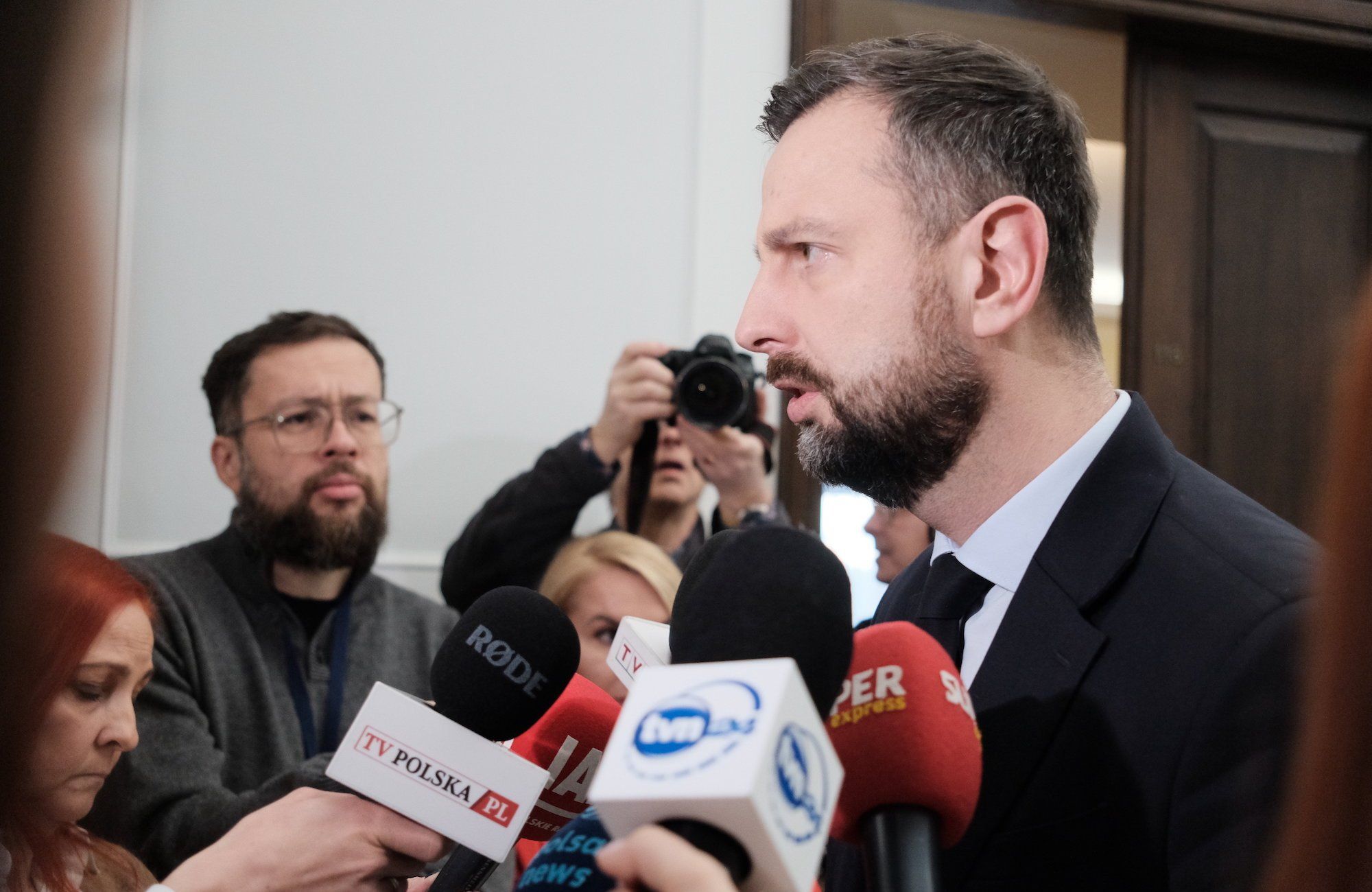 Władysław Kosiniak-Kamysz przemawia do mikrofonów w Sejmie. Stoi lewym profilem do obiektywu.