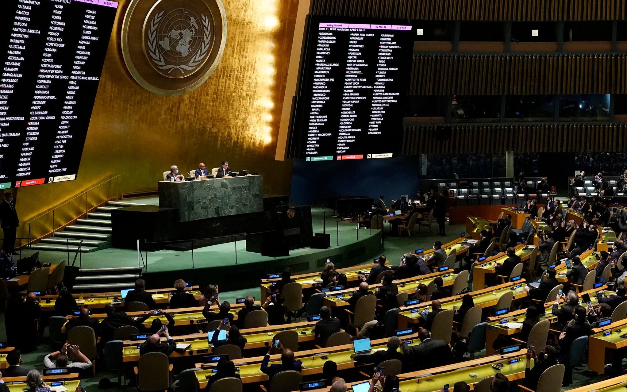 Delegates vote at the UN General Assembly Emergency session in New York on March 2, 2022, after a resolution condemning Russian invasion of Ukraine passed. - The UN overwhelmingly adopted a resolution that "demands" Russia "immediately" withdraw from Ukraine, in a powerful rebuke of Moscow's invasion by the global body charged with peace and security. (Photo by TIMOTHY A. CLARY / AFP)