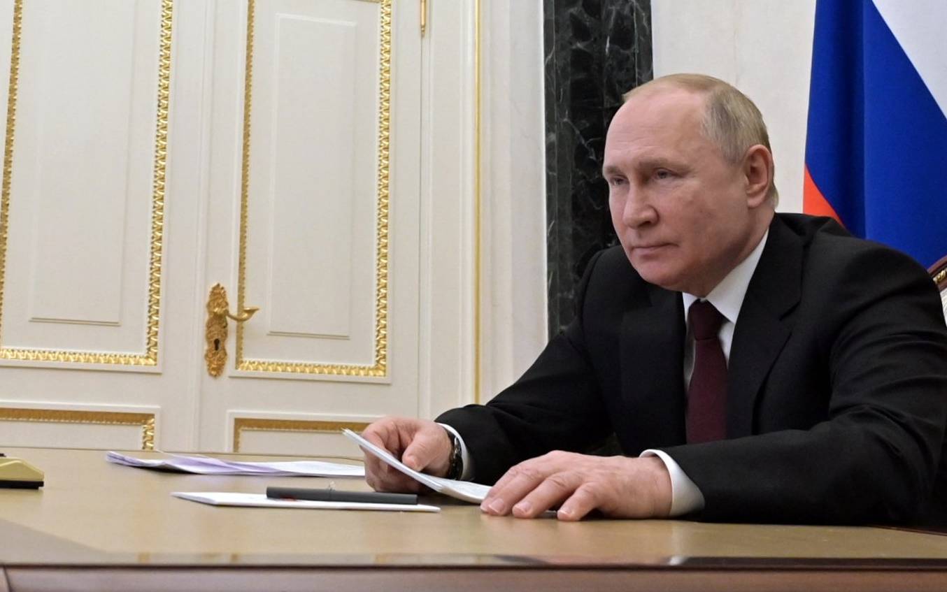 Russian President Vladimir Putin chairs a meeting with members of Russian paralympic teams ahead of Beijing 2022 Winter Paralympic Games via a teleconference call, in Moscow on February 21, 2022. (Photo by Alexey NIKOLSKY / Sputnik / AFP)