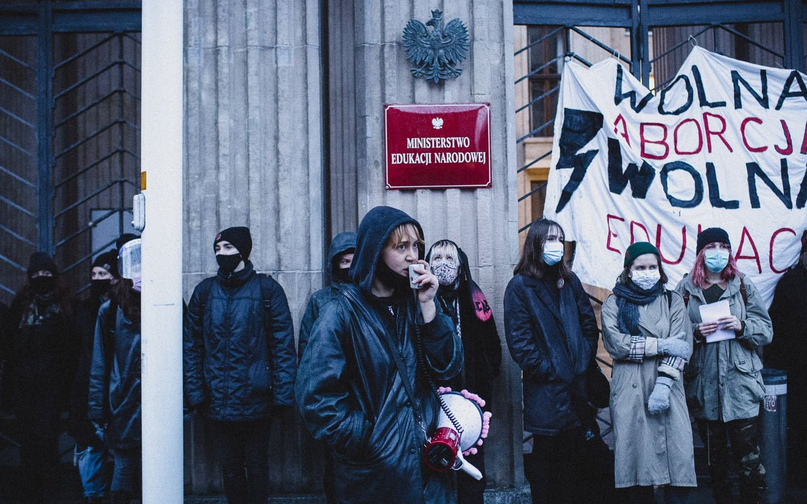 Grafika do artykułu "Dla mnie ten rząd już jest obalony" - mówią aktywistki, które przykuły się do bramy MEN [WYWIAD]