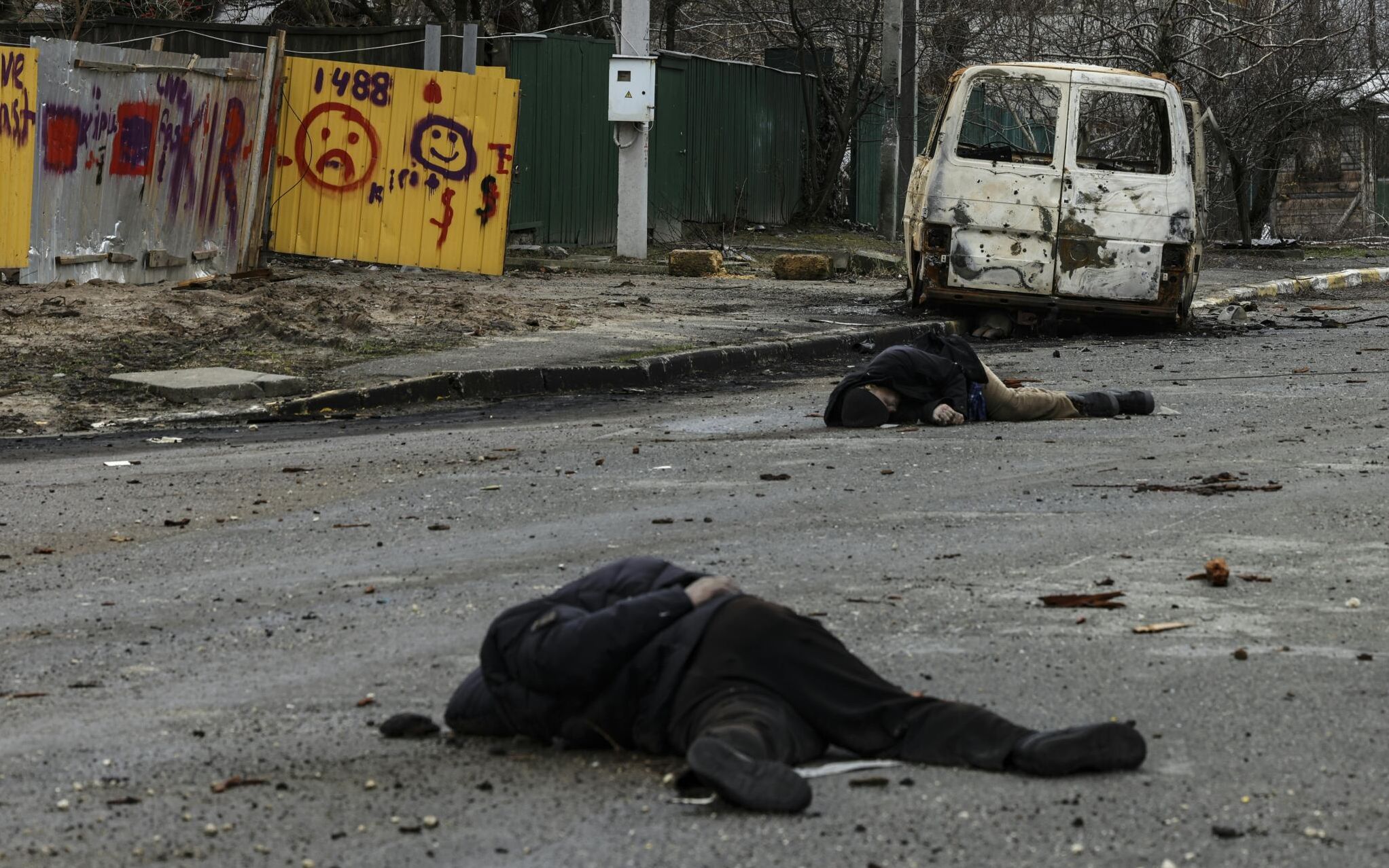 EDITORS NOTE: Graphic content / Dead bodies lie on a street in Bucha, northwest of Kyiv, on April 2, 2022, as Ukraine says Russian forces are making a "rapid retreat" from northern areas around Kyiv and the city of Chernigiv. - The bodies of at least 20 men in civilian clothes were found lying in a single street Saturday after Ukrainian forces retook the town of Bucha near Kyiv from Russian troops, AFP journalists said. Russian forces withdrew from several towns near Kyiv in recent days after Moscow's bid to encircle the capital failed, with Ukraine declaring that Bucha had been "liberated". (Photo by RONALDO SCHEMIDT / AFP)