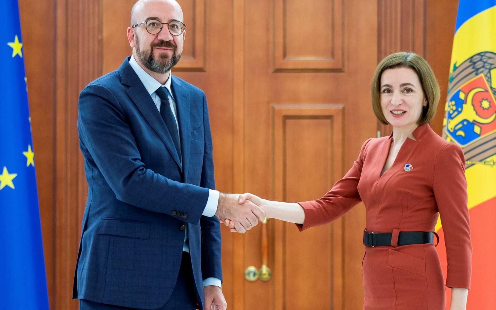 European Council President Charles Michel (L) shakes hands with Moldova's President Maia Sandu during their meeting in Chisinau on May 4, 2022. - European Council President Charles Michel on May 4 pledged to increase EU military aid to Moldova, Ukraine's neighbour that has seen a series of attacks in a pro-Moscow separatist region. (Photo by BOGDAN TUDOR / AFP)
