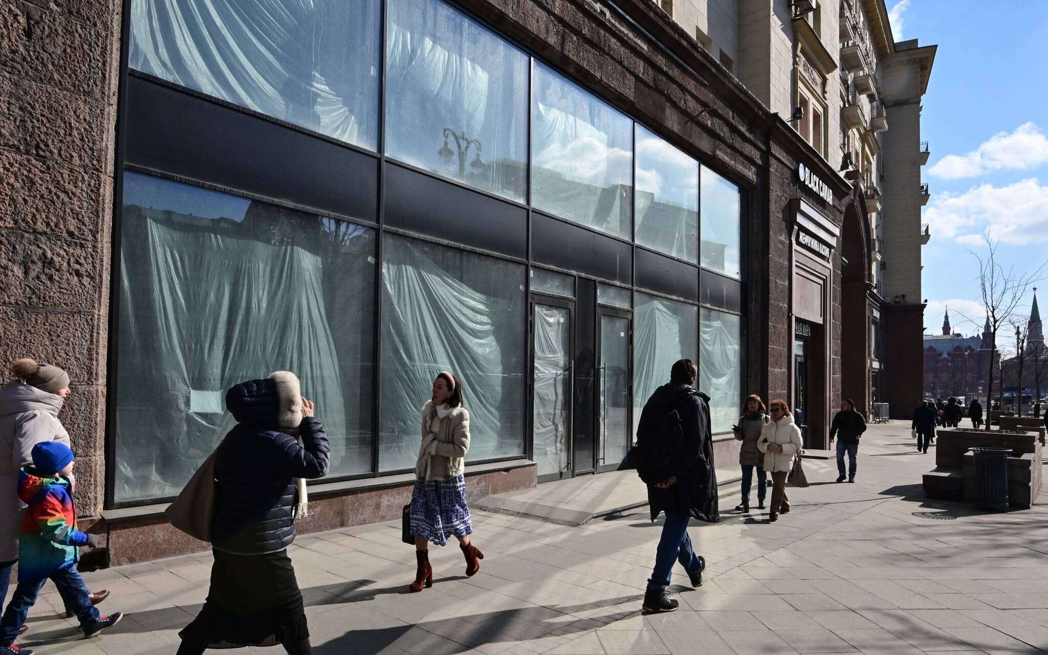 People walk past empty retail space on Tverskaya street in central Moscow on March 16, 2022. - On February 24, Putin ordered Russian troops to pour into pro-Western Ukraine, triggering unprecedented Western sanctions against Moscow and sparking an exodus of foreign corporations including H&amp;M, McDonald's and Ikea. (Photo by - / AFP)