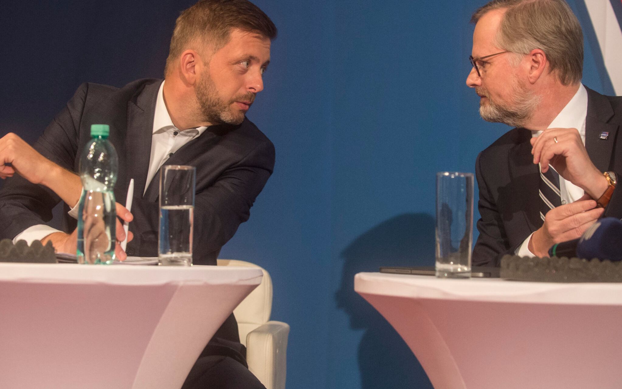 The leader of Czech Republic's Civic Party (ODS) and Together's (SPOLU) coalition candidate for prime minister Petr Fiala (R) talks with  STAN (Mayors and Independents) leader Vit Rakusan (L) from Pirates/STAN coalition as they attend the last debate at the public radio before the poll stations open for the parliamentary election on October 8, 2021 in Prague. - Czech Prime Minister Andrej Babis is seeking a second straight victory for his populist ANO political party despite his lukewarm handling of the Covid-19 pandemic and his clash with the law. (Photo by Michal Cizek / AFP)