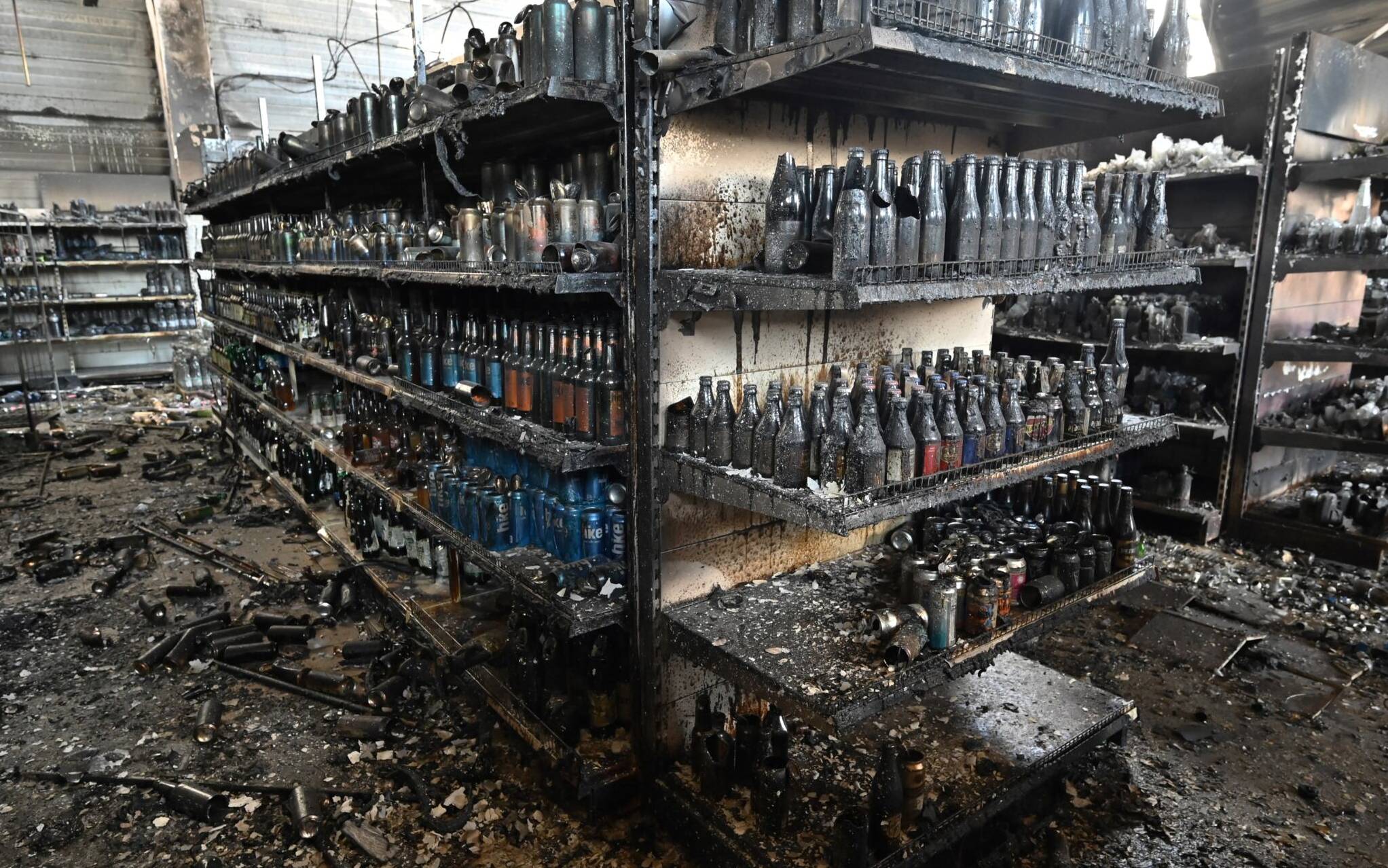 A photograph taken on June 28, 2022 shows charred goods in a grocery store of the destroyed Amstor mall in Kremenchuk, one day after it was hit by a Russian missile strike according to Ukrainian authorities. - A Russian missile strike on a crowded mall in central Ukraine killed at least 18 people in what Group of Seven leaders branded "a war crime" at a meeting in Germany where they looked to step up sanctions on Moscow. The leaders vowed that Russian President and those responsible would be held to account for June 27's strike in the city of Kremenchuk, carried out during the shopping mall's busiest hours. (Photo by Genya SAVILOV / AFP)