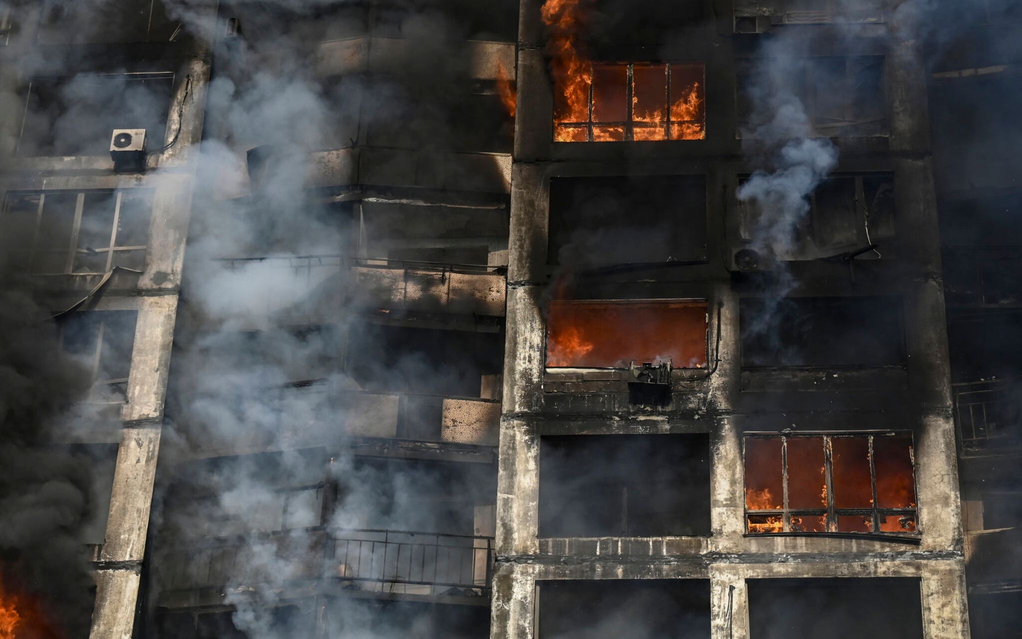 Firefighters extinguish a fire in an apartment building in Kyiv on March 15, 2022, after strikes on residential areas killed at least two people, Ukraine emergency services said as Russian troops intensified their attacks on the Ukrainian capital. - A series of powerful explosions rocked residential districts of Kyiv early today killing two people, just hours before talks between Ukraine and Russia were set to resume. (Photo by Aris Messinis / AFP)