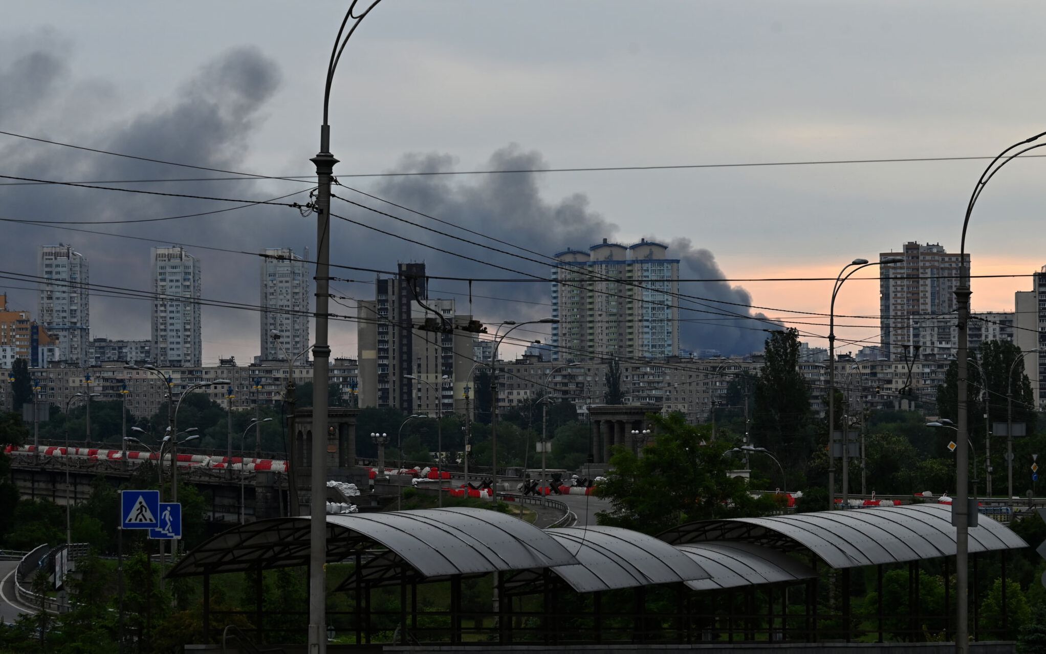 This photograph taken on June 5, 2022 shows smoke after several explosions hit the Ukrainian capital Kyiv early morning. - "Several explosions in Darnytsky and Dniprovsky districts of city. Services are extinguishing," Kyiv Mayor said on Telegram. (Photo by Sergei SUPINSKY / AFP)