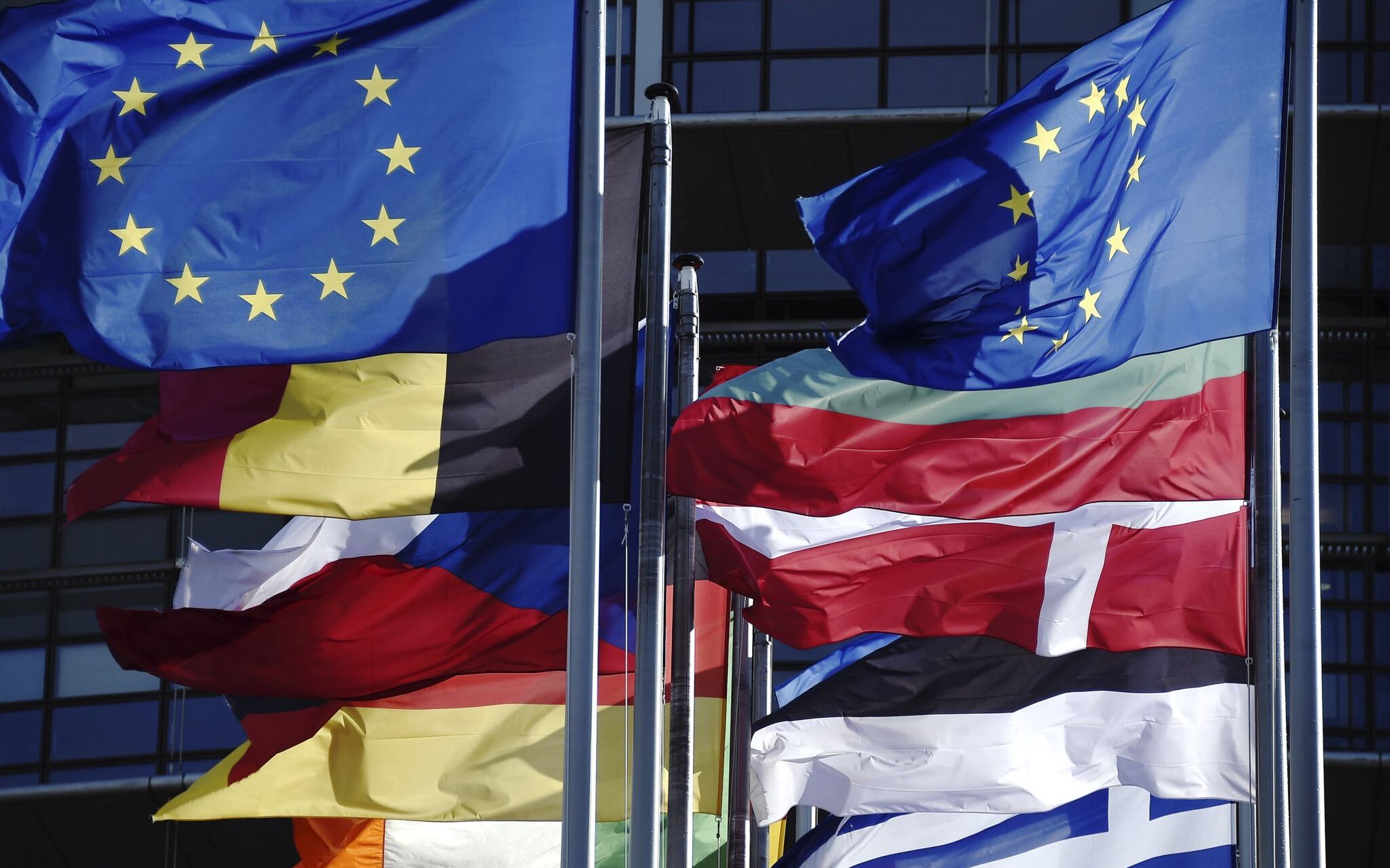 A photograph taken on February 15, 2022 shows EU flags and Union European members' flags flying near the European Parliament in Strasbourg, eastern France. (Photo by FREDERICK FLORIN / AFP)