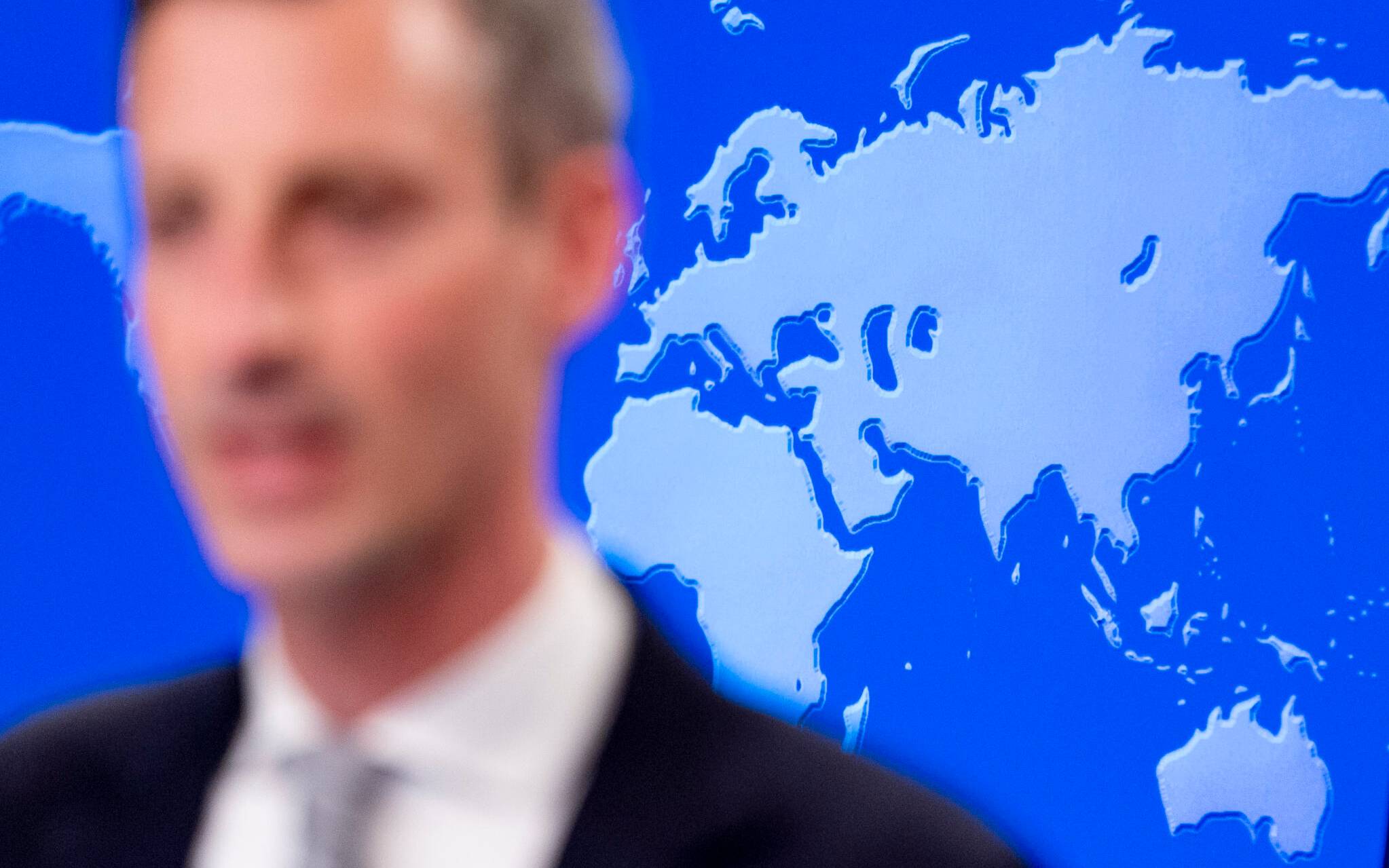A map of the world is visible behind State Department spokesman Ned Price speaks during a news conference at the State Department in Washington, February 28, 2022. (Photo by Andrew Harnik / POOL / AFP)