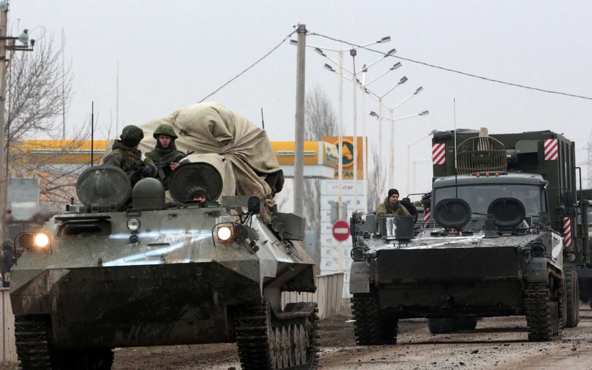 Russian army military vehicles are seen in Armyansk, Crimea, on February 25, 2022. - Ukrainian forces fought off Russian invaders in the streets of the capital Kyiv on February 25, 2022, as President Volodymyr Zelensky accused Moscow of targeting civilians and called for more international sanctions. Pre-dawn blasts in Kyiv set off a second day of violence after Russian President Vladimir Putin defied Western warnings to unleash a full-scale invasion on on February 24, 2022, that quickly claimed dozens of lives and displaced at least 100,000 people. (Photo by STRINGER / AFP)