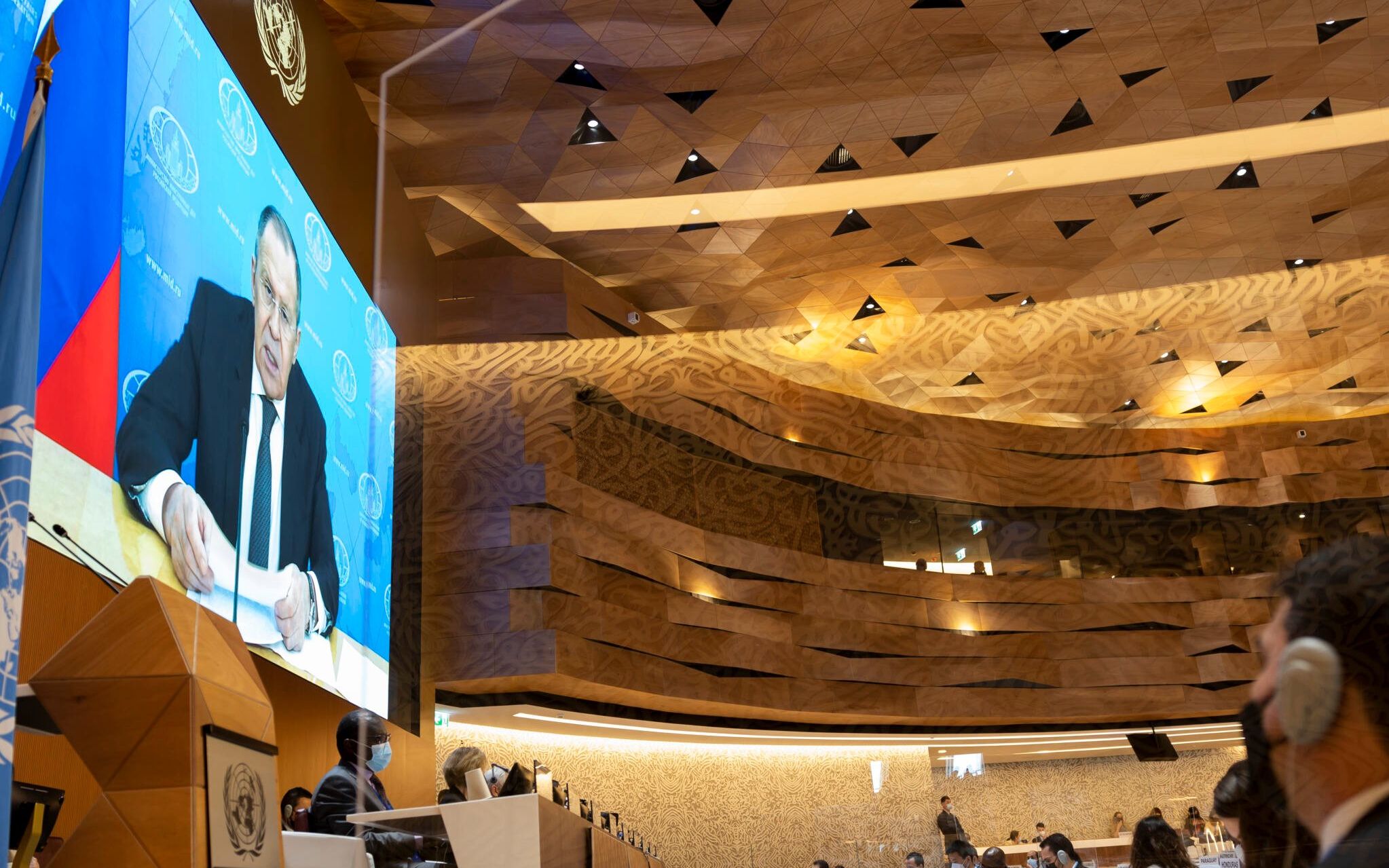 Diplomats look on as Russia's foreign minister Sergei Lavrov (on screen) addresses with a pre-recorded video message at the 49th session of the UN Human Rights Council at the European headquarters of the United Nations in Geneva, Switzerland, on March 1, 2022. - Ukraine's ambassador and diplomats from a wide number of countries staged a walkout when Sergei Lavrov's pre-recorded video message began to play, in protest against Moscow's invasion of Ukraine (Photo by SALVATORE DI NOLFI / POOL / AFP)