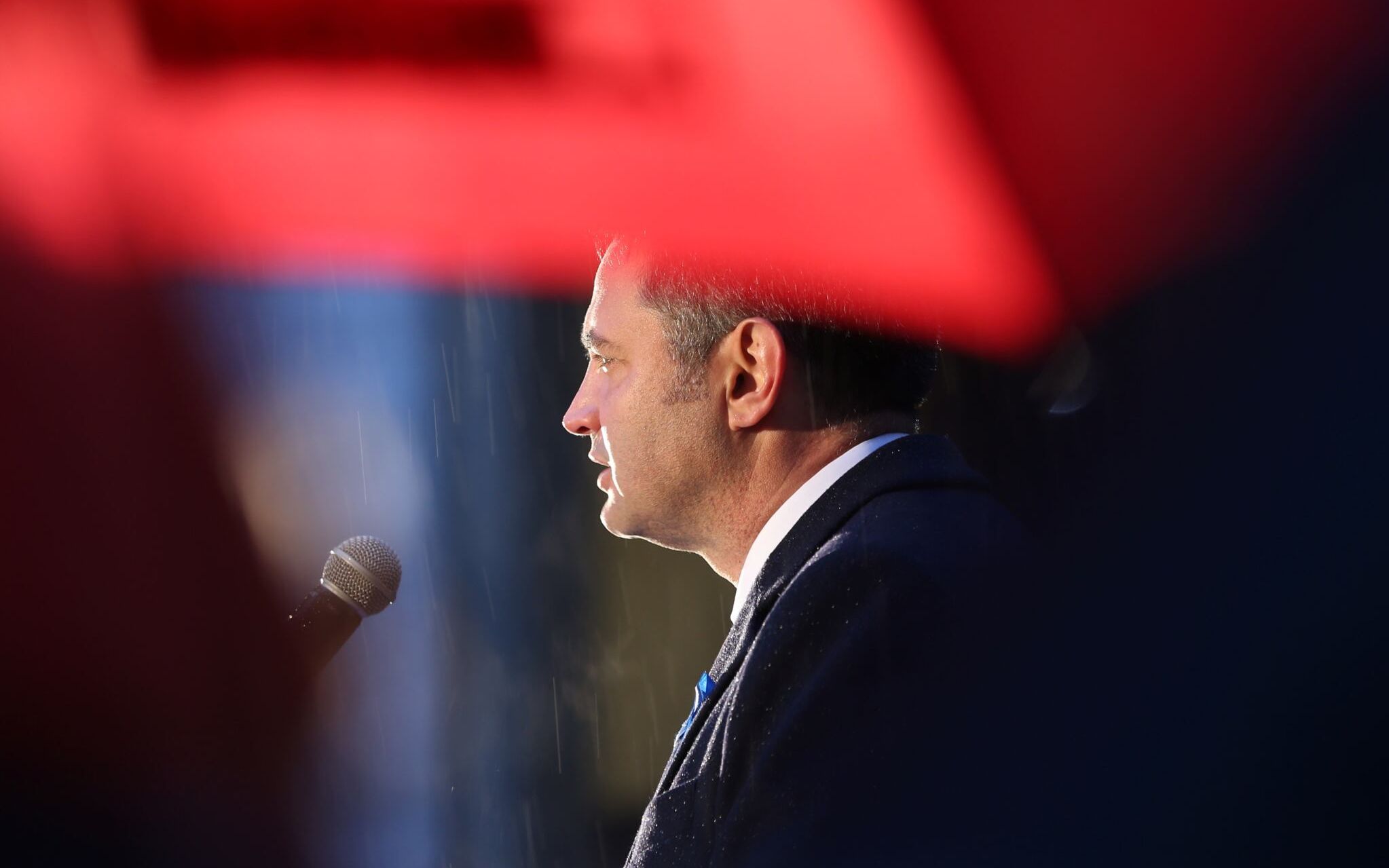 Hungary's opposition alliance's candidate for prime minister, Peter Marki-Zay delivers a speech as it rains during an event to close his election campaign in Budapest on April 2, 2022, on the eve of Hungary's parliamentary elections. - Nationalist Hungarian Prime Minister Orban faces perhaps the toughest electoral task of his 12 years in power on April 3 as he faces a united opposition in an unpredictable general election, after a campaign dominated by Russia's invasion of neighbouring Ukraine. (Photo by FERENC ISZA / AFP)