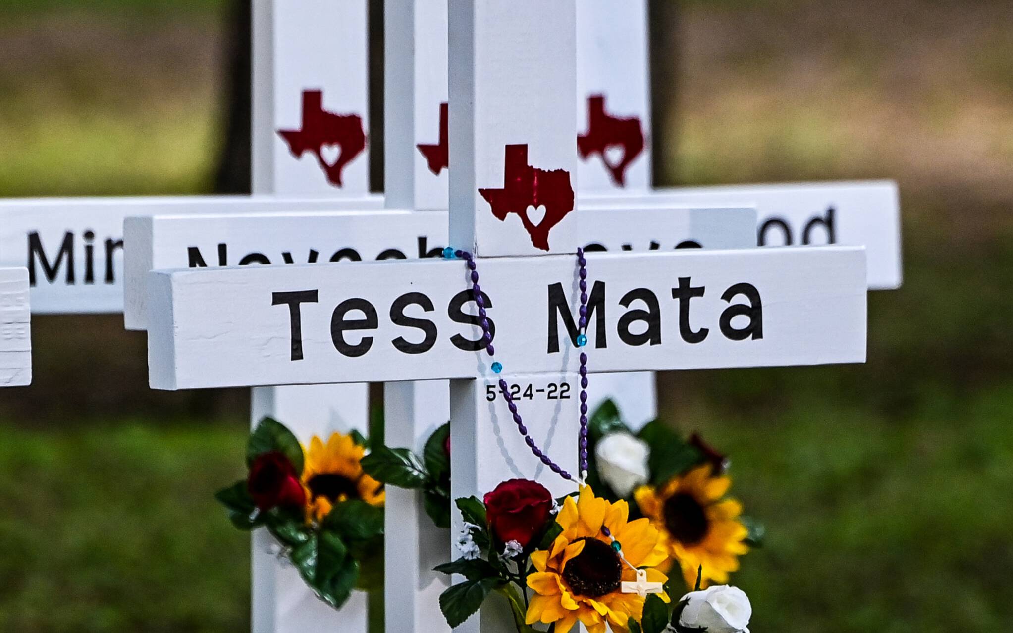 Crosses adorn a makeshift memorial for the shooting victims at Robb Elementary School in Uvalde, Texas, on May 26, 2022. - Grief at the massacre of 19 children at the elementary school in Texas spilled into confrontation on May 25, as angry questions mounted over gun control -- and whether this latest tragedy could have been prevented. The tight-knit Latino community of Uvalde on May 24 became the site of the worst school shooting in a decade, committed by a disturbed 18-year-old armed with a legally bought assault rifle. (Photo by CHANDAN KHANNA / AFP)