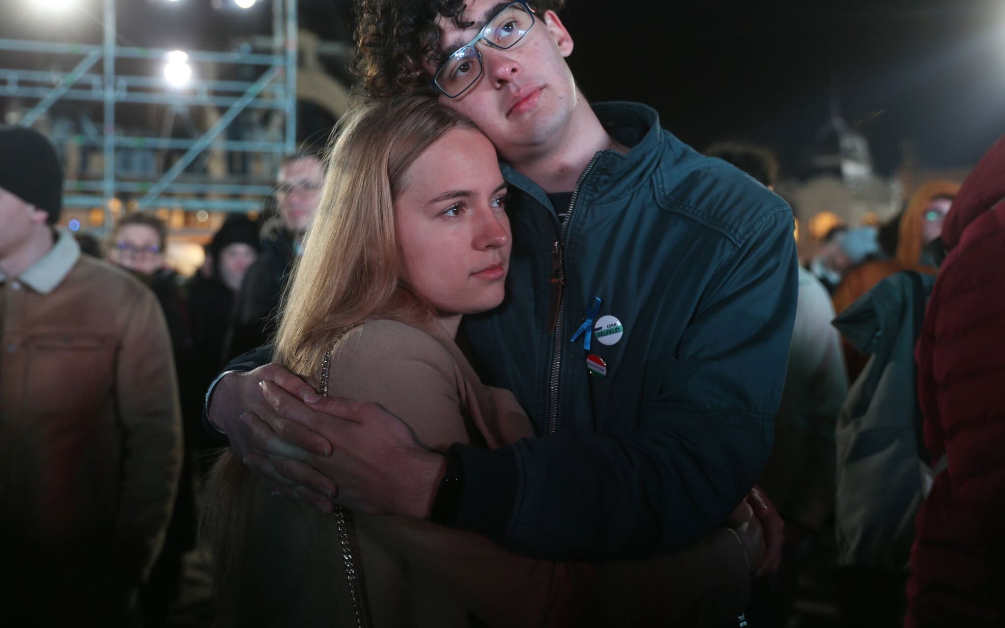 People wait for results of the opposition coalition parties during the election night on the iceskating pitch in Budapest on April 03, 2022. - With 57 percent of the votes counted, Nationalist Hungarian Prime Minister Orban's Fidesz party had gained 55.75 percent of the vote versus 32.55 percent for the six-party opposition coalition. (Photo by FERENC ISZA / AFP)