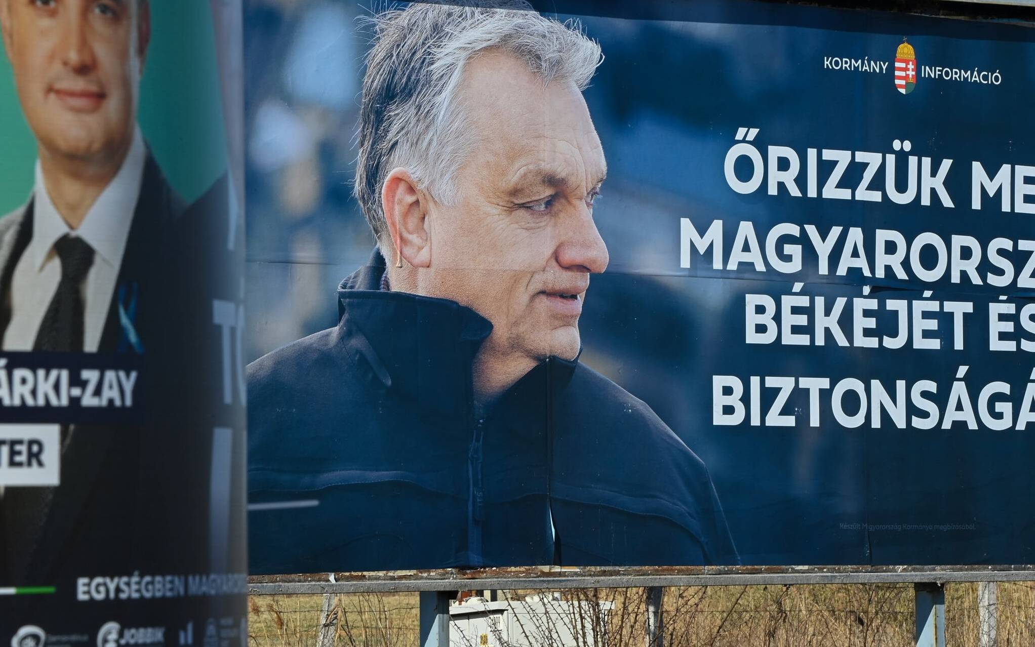 A giant election poster of the Hungarian Prime Minister Viktor Orban (R) is seen, can read on it 'Save Hungary's peace and safety!' , with smaller one of Orban's opponent Peter Marki-Zay (L) in Kisvarda town, eastern Hungary, about 300 km from Hungarian capital Budapest on March 28, 2022. - Facing Hungary's tightest election for years on Sunday, Prime Minister Viktor Orban can count on a win in a party stronghold near the Ukraine border with fears of involvement in the war next door dominating the campaign. (Photo by ATTILA KISBENEDEK / AFP)