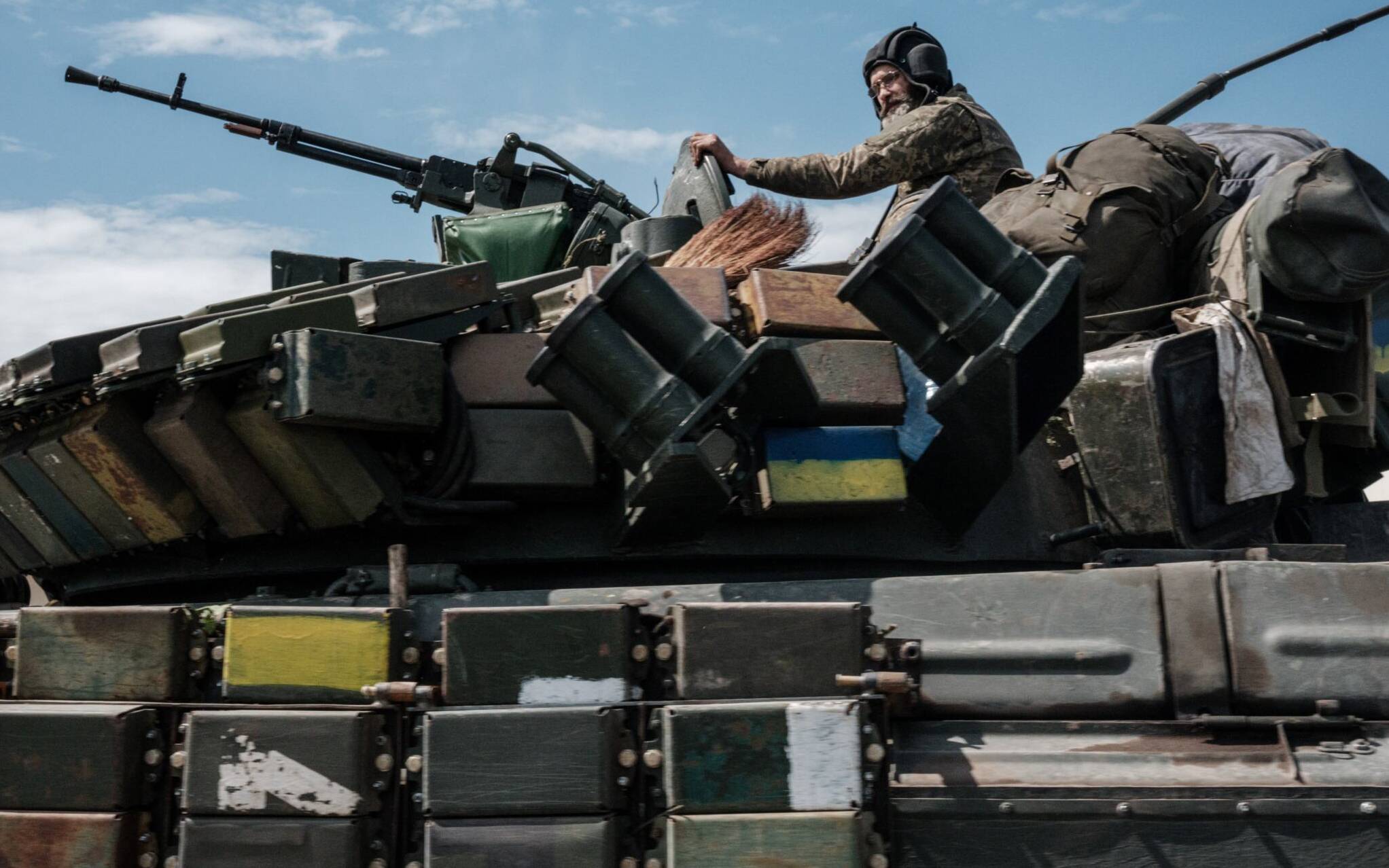 A Ukrainian soldier sits on a tank carryied by a transporter near Bakhmut, eastern Ukraine, on May 12, 2022, amid the Russian invasion of Ukraine. (Photo by Yasuyoshi CHIBA / AFP)