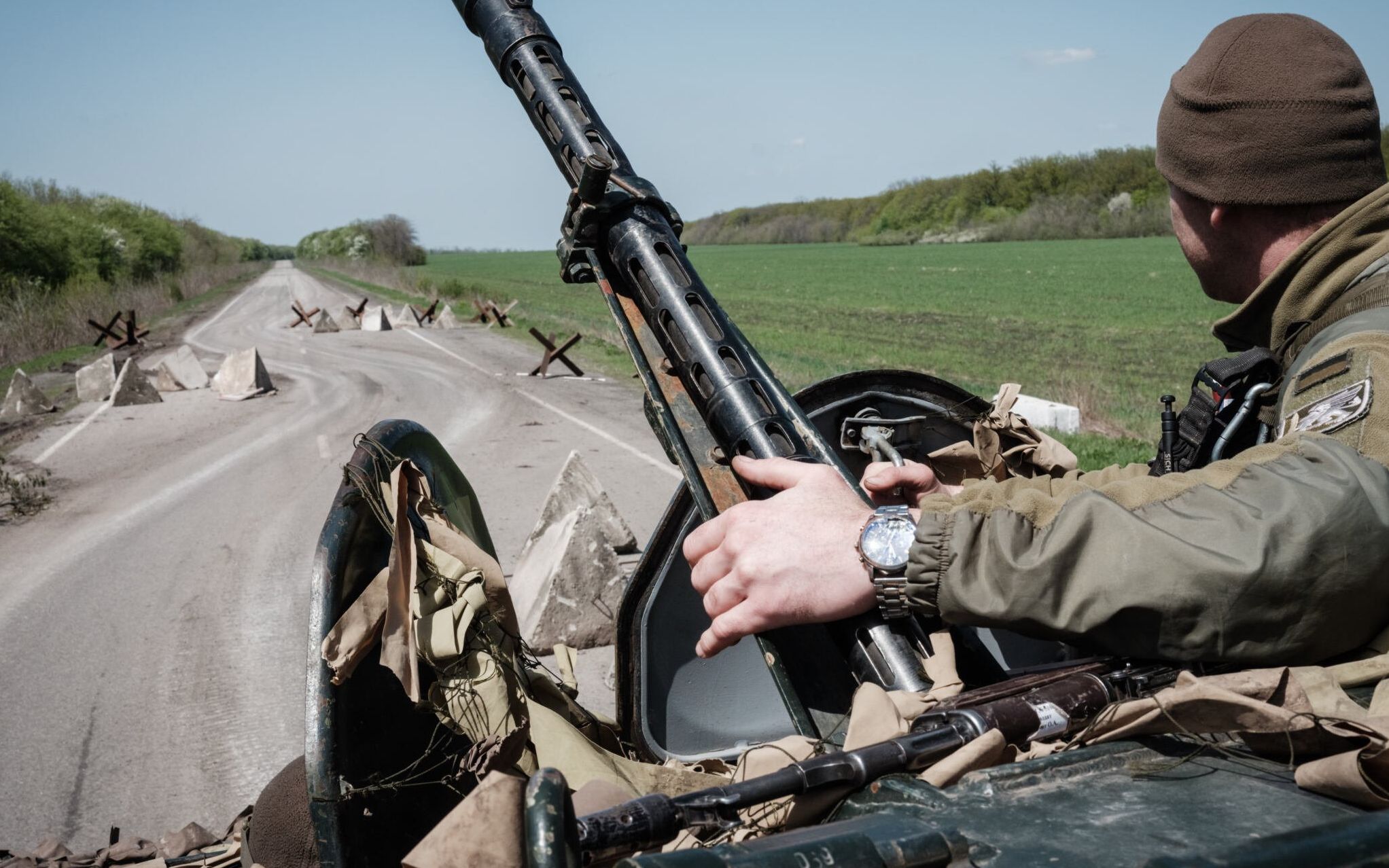 A Ukrainian soldier sits on a Armoured personnel carrier (APC) driving on a road near Sloviansk, eastern Ukraine, on April 26, 2022, amid the Russian invasion of Ukraine. (Photo by Yasuyoshi CHIBA / AFP)