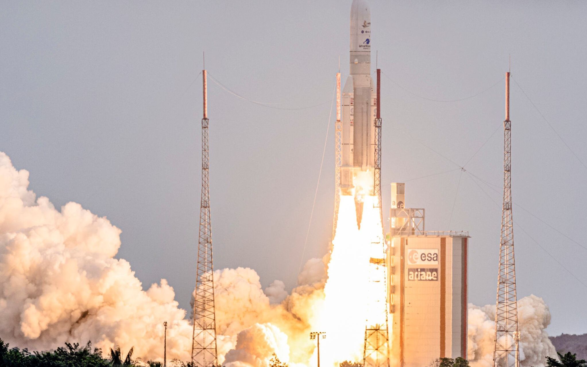Arianespace's Ariane 5 rocket with NASAs James Webb Space Telescope onboard lifts up from the launchpad, at the Europes Spaceport, the Guiana Space Center in Kourou, French Guiana, on December 25, 2021. - The telescope, the most powerful space observatory ever built, is now tentatively set for launch on Christmas Day, after decades of waiting. An engineering marvel, it will help answer fundamental questions about the Universe, peering back in time 13 billion years. (Photo by jody amiet / AFP)