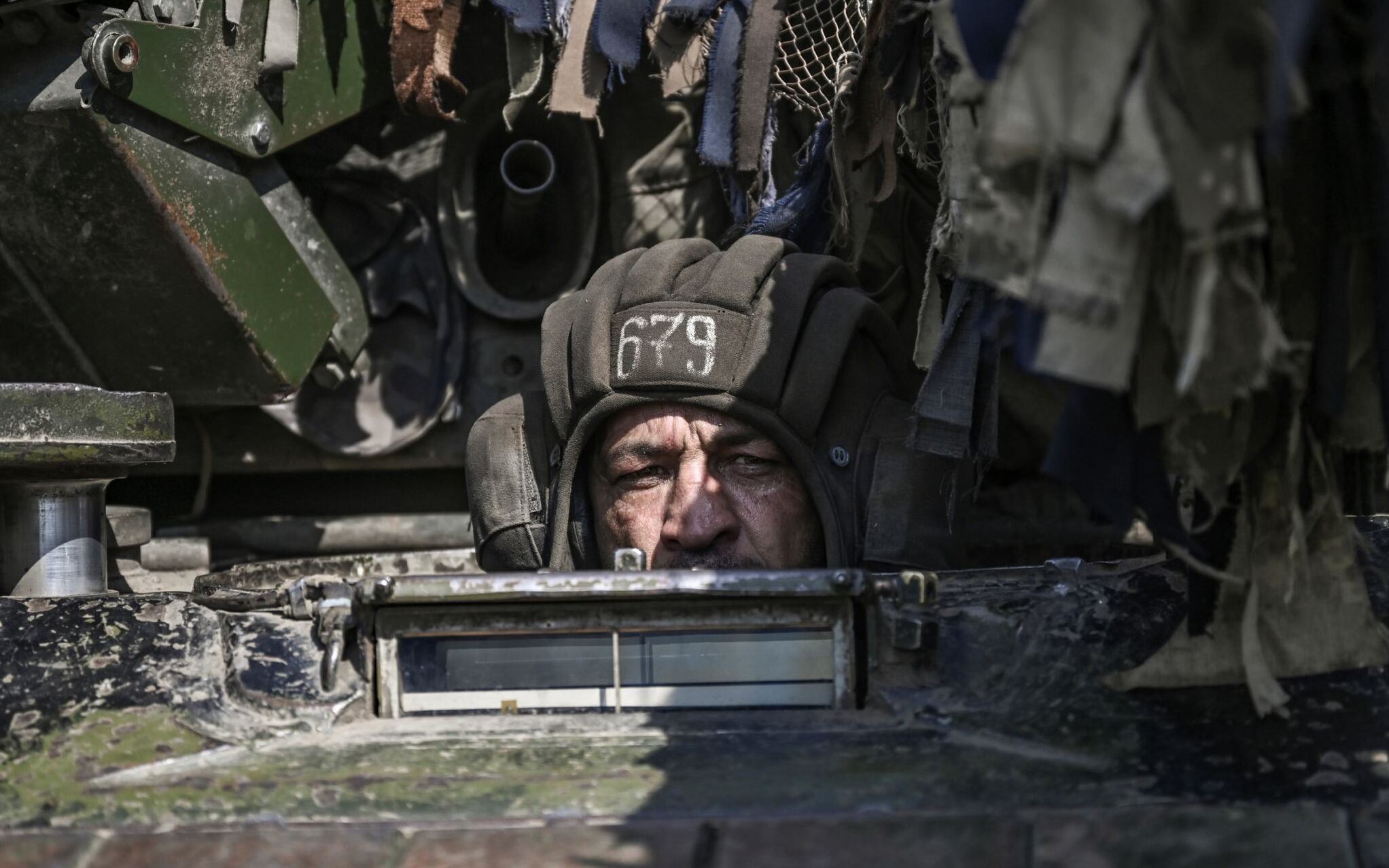 A Ukrainian serviceman drives a Battle Tank (MBT) towards the front line at the eastern Ukrainian region of Donbas on June 14, 2022, amid Russian invasion of Ukraine. (Photo by ARIS MESSINIS / AFP)