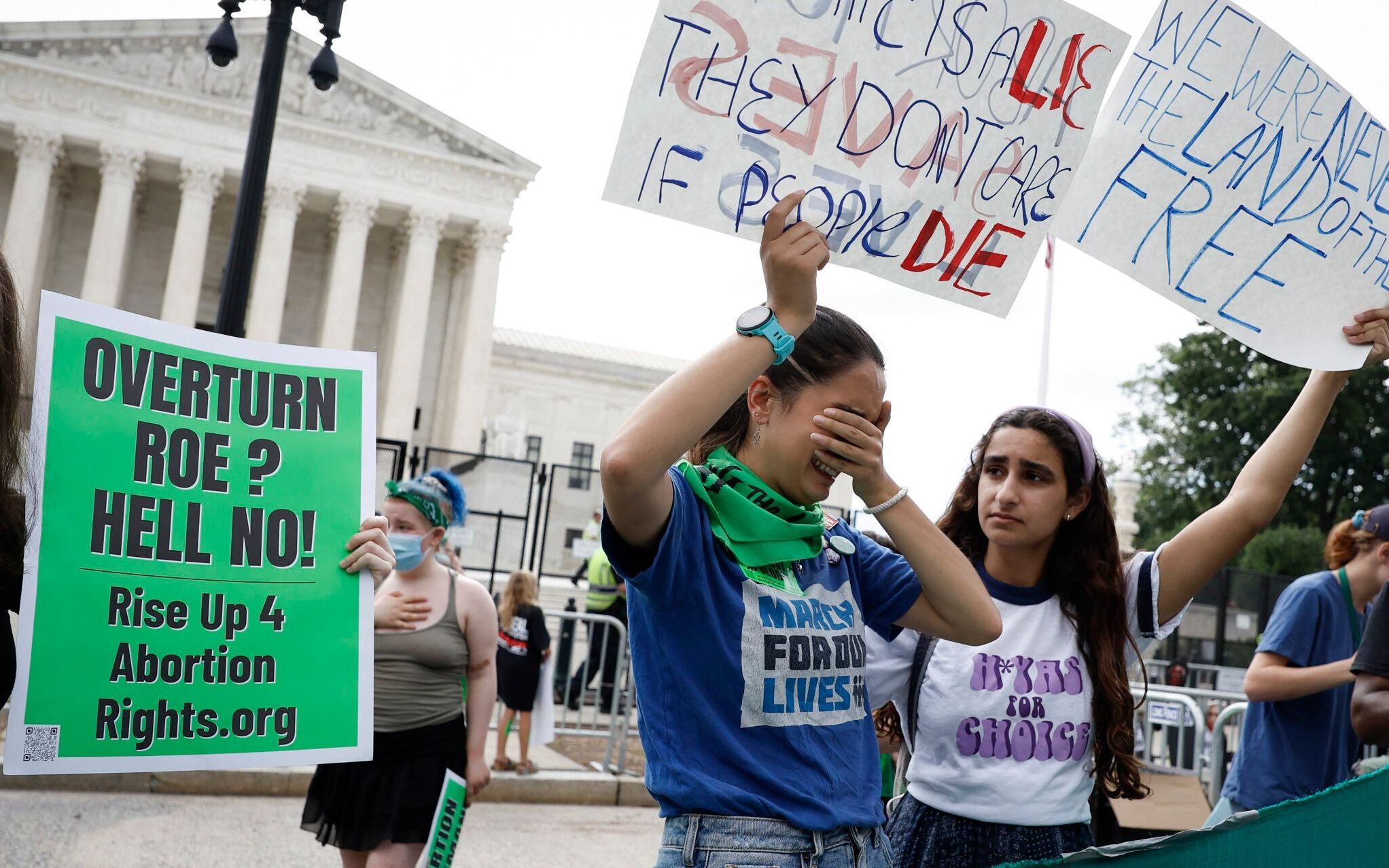 WASHINGTON, DC - JUNE 24: Abortion-rights activists Carrie McDonald (C) and Soraya Bata react to the Dobbs v Jackson Women's Health Organization ruling in front of the U.S. Supreme Court on June 24, 2022 in Washington, DC. The Court's decision in Dobbs v Jackson Women's Health overturns the landmark 50-year-old Roe v Wade case and erases a federal right to an abortion.   Anna Moneymaker/Getty Images/AFP (Photo by Anna Moneymaker / GETTY IMAGES NORTH AMERICA / Getty Images via AFP)