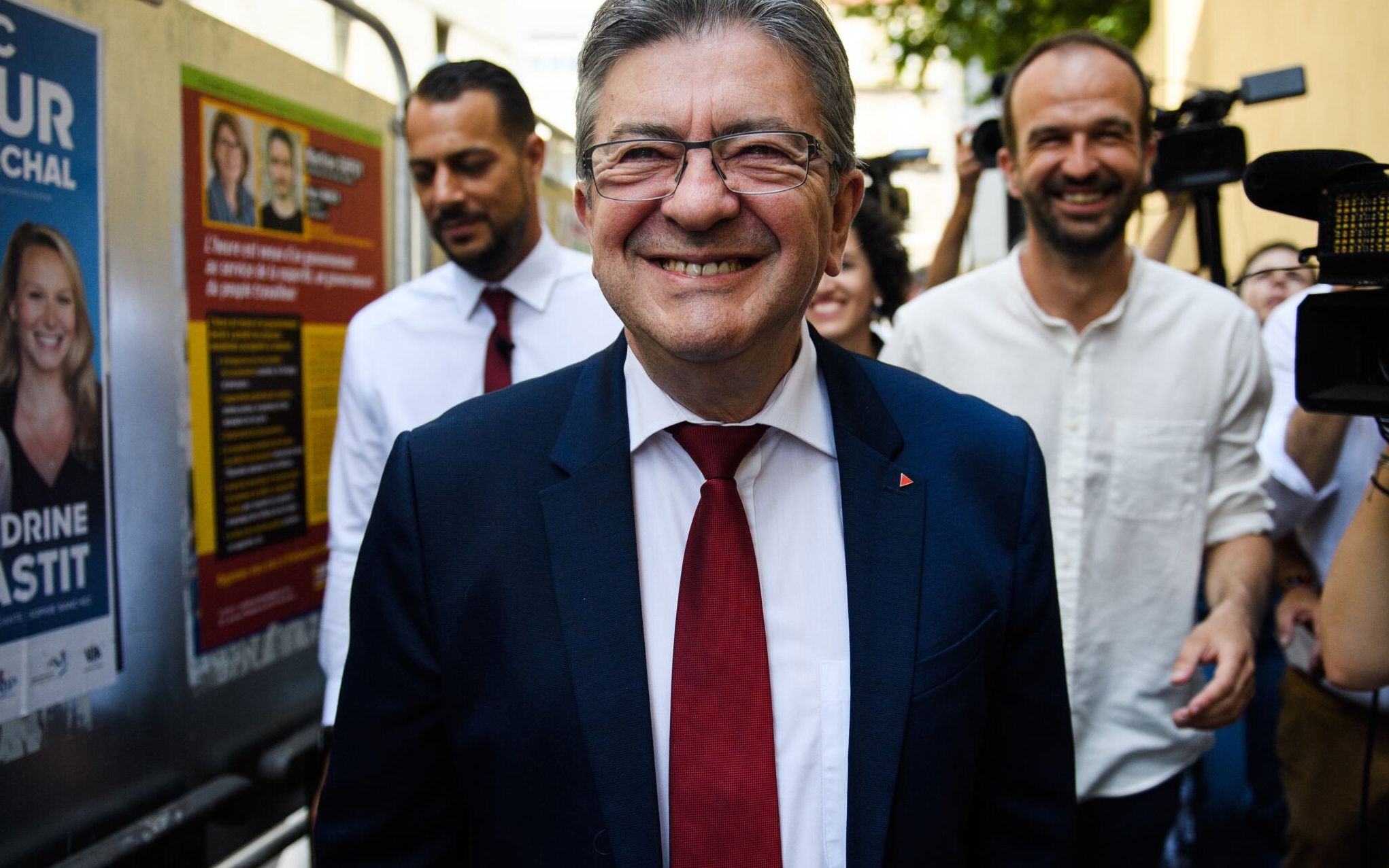 French leftist La France Insoumise (LFI) party leader, Member of Parliament and leader of left-wing coalition Nupes (Nouvelle Union Populaire Ecologique et Sociale - New Ecologic and Social People's Union), Jean-Luc Melenchon (C), Left-wing coallition Nupes, member of LFI and candidate in the 4th constituency of the Bouches du Rhone department Manuel Bompard (R) and Left-wing coallition Nupes, member of LFI and candidate in the 7th constituency of the Bouches du Rhone department Sebastien Delogu (L) leave the polling station after voting in the second stage of parliamentary elections, in Marseille, southern France on June 19, 2022. (Photo by CLEMENT MAHOUDEAU / AFP)