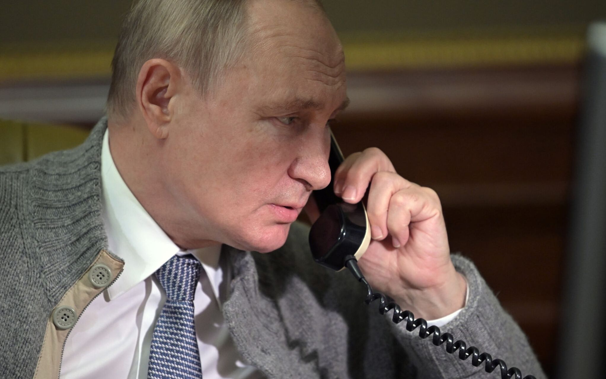 Russia's President Vladimir Putin speaks on the phone with participants of "The Christmas Tree Wishes" campaign in Strelna, outside St. Petersburg, on December 27, 2021. - The goal of the campaign is to make the New Year's dreams of orphans, children from low-income families, and disabled kids come true. (Photo by Alexey NIKOLSKY / SPUTNIK / AFP)