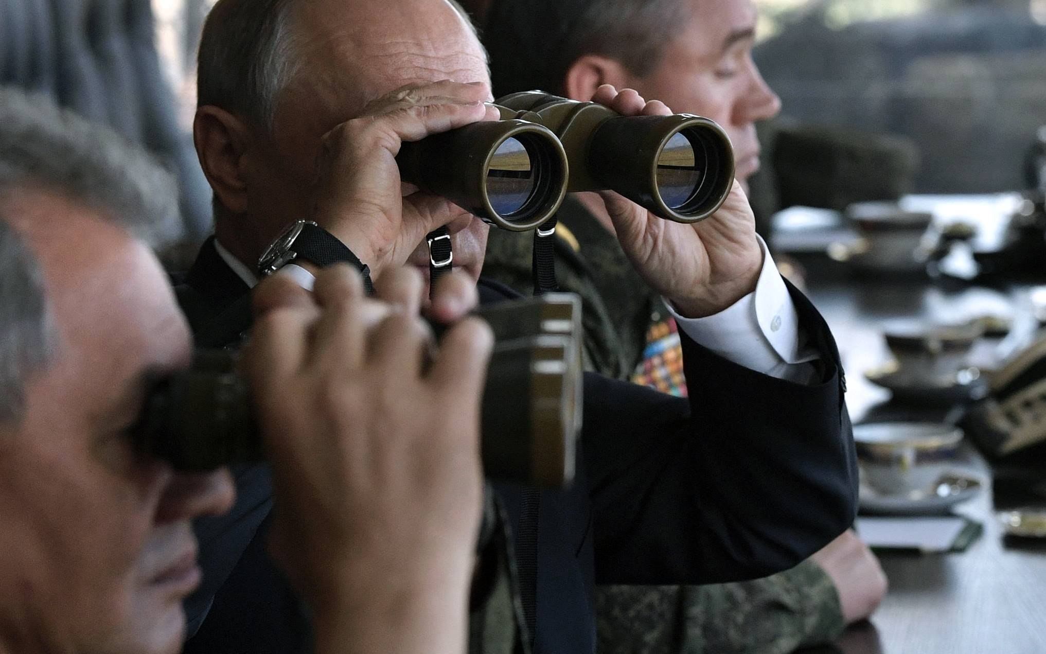 Russia's President Vladimir Putin (C), Defence Minister Sergei Shoigu (L) and Chief of the General Staff of the Russian Armed Forces Valery Gerasimov watch the Vostok-2018 (East-2018) military drills at Tsugol training ground not far from the Chinese and Mongolian border in Siberia, on September 13, 2018. (Photo by Alexey NIKOLSKY / SPUTNIK / AFP)