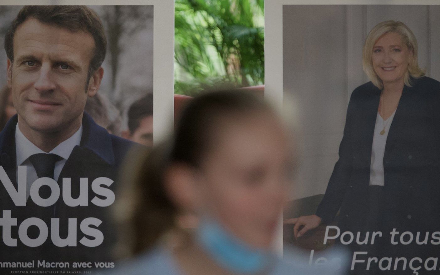 Pictures of candidates Emmanuel Macron (L) and Marine Le Pen are displayed during the second round of voting in the French presidential elections at the French Embassy in Beijing on April 24, 2022. (Photo by Noel Celis / AFP)