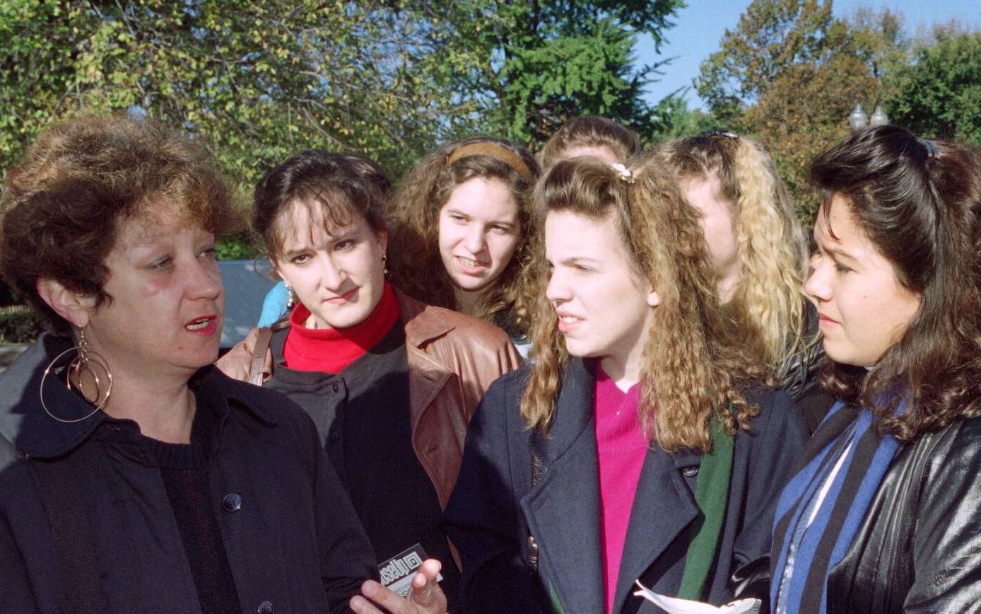 The plaintive in the 1973 Supreme Court case Roe vs Wade, Norma Mc Corvey(L known as "Jane Roe" talks to teenage girls on the steps of the U.S. Supreme Court in Washington on October, 30, 1990. The girls were waiting to attend the hearing of Rust v. Sullivan, wich challenges federal regulations barring the staffs of government-subsidized family planning clinics from discussing abortion with clients. (Photo by Luke FRAZZA / AFP)