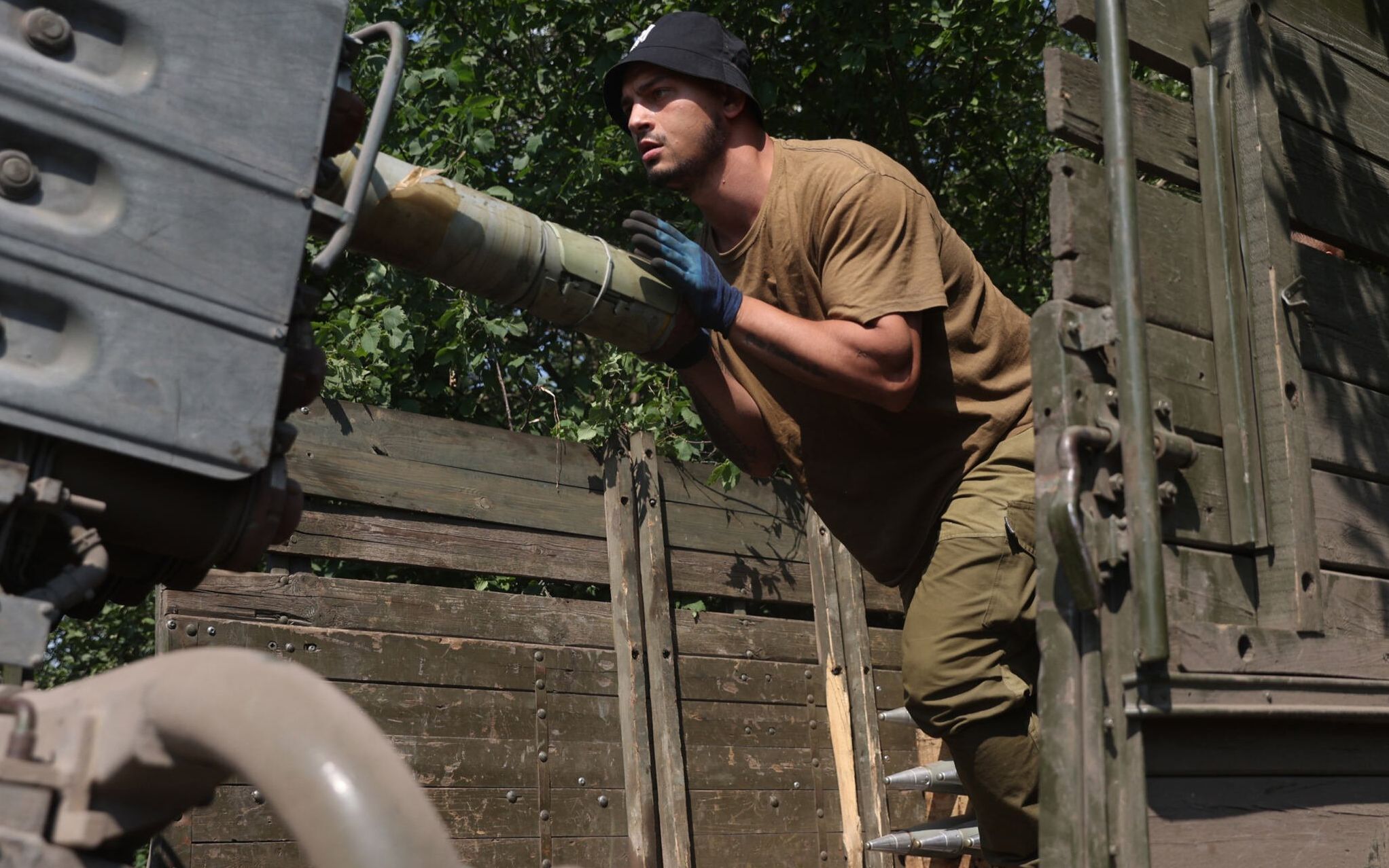 A Ukrainian artilleryman loads a BM-21 Grad multiple rocket launcher near Izyum, south of Kharkiv, on June 11, 2022 amid Russian invasion of Ukraine. (Photo by Anatolii STEPANOV / AFP)