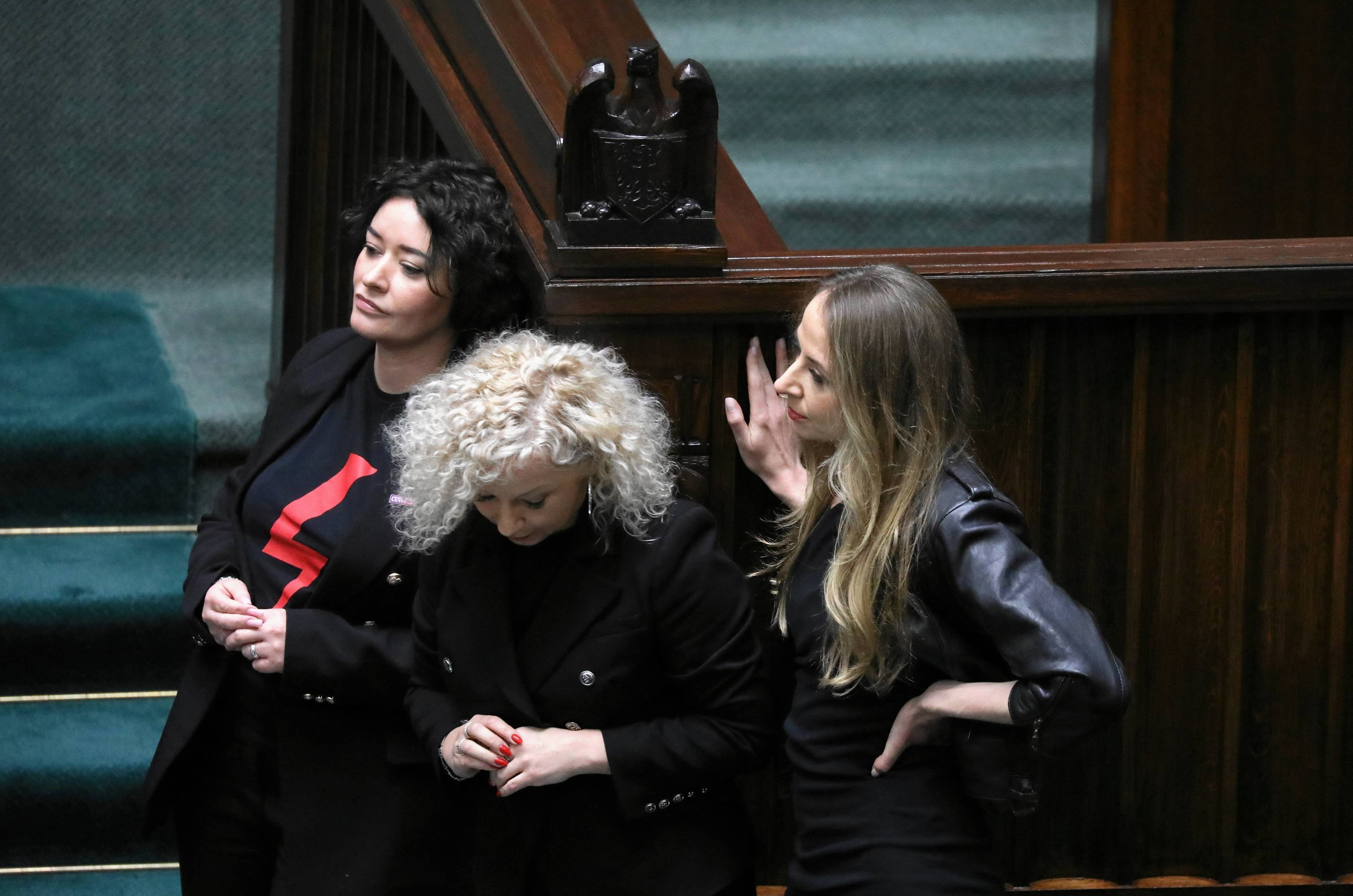 Ubrane na czarno posłanki Żukowska, Dziemianowicz-Bąk i Kotula stoją razem i czekają na swoją kolej na mówinicy sejmowej.