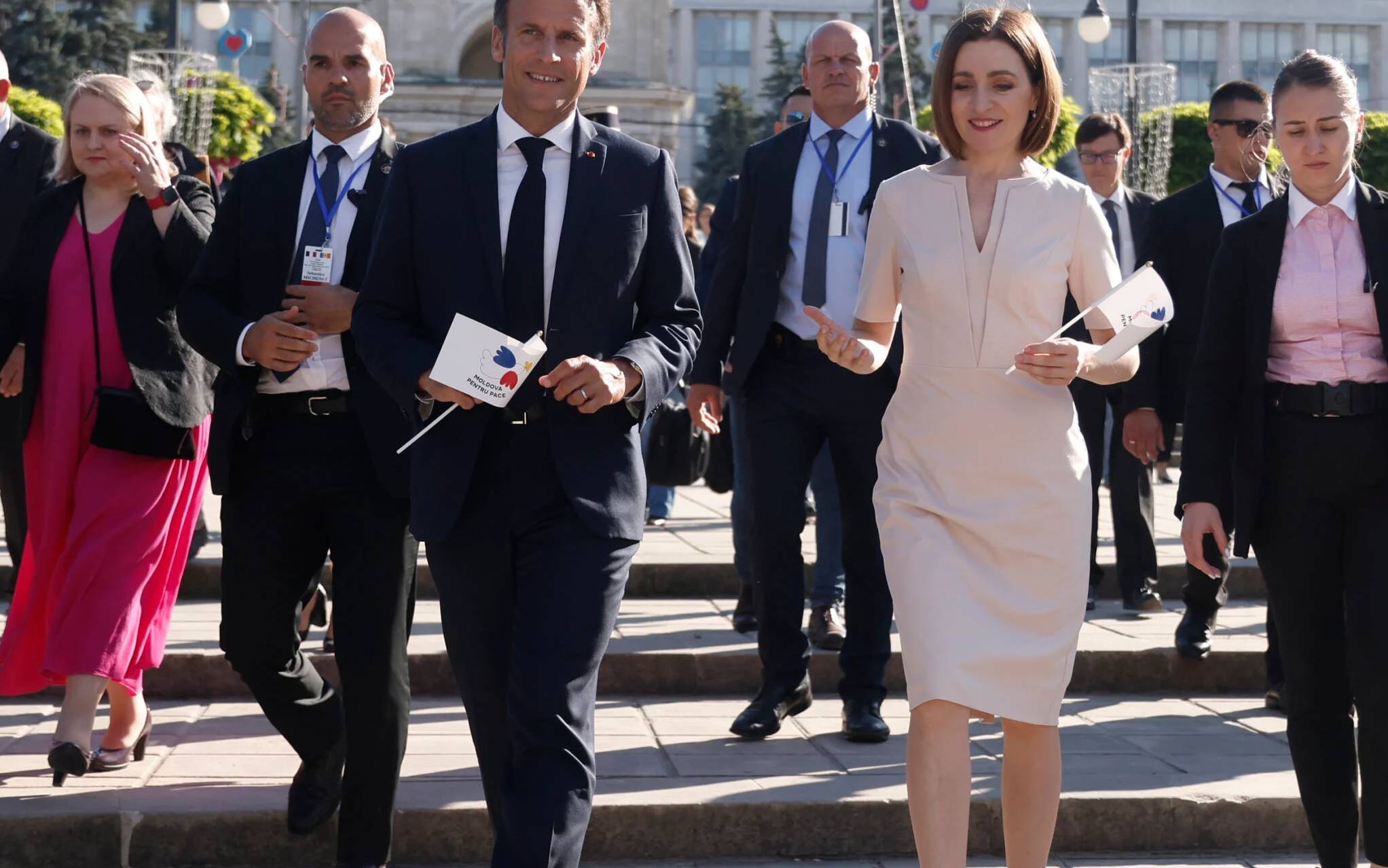 French President Emmanuel Macron and the President of Moldova Maia Sandu are seen during a walk-about following their meeting as part of Macron's official visit to the region, in Chisinau on June 15, 2022. - French President Emmanuel Macron (L) with President of Moldova Maia Sandu (R) during a walk-about following their meeting in Chisinau, Moldova, 15 June 2022. (Photo by Yoan VALAT / POOL / AFP)