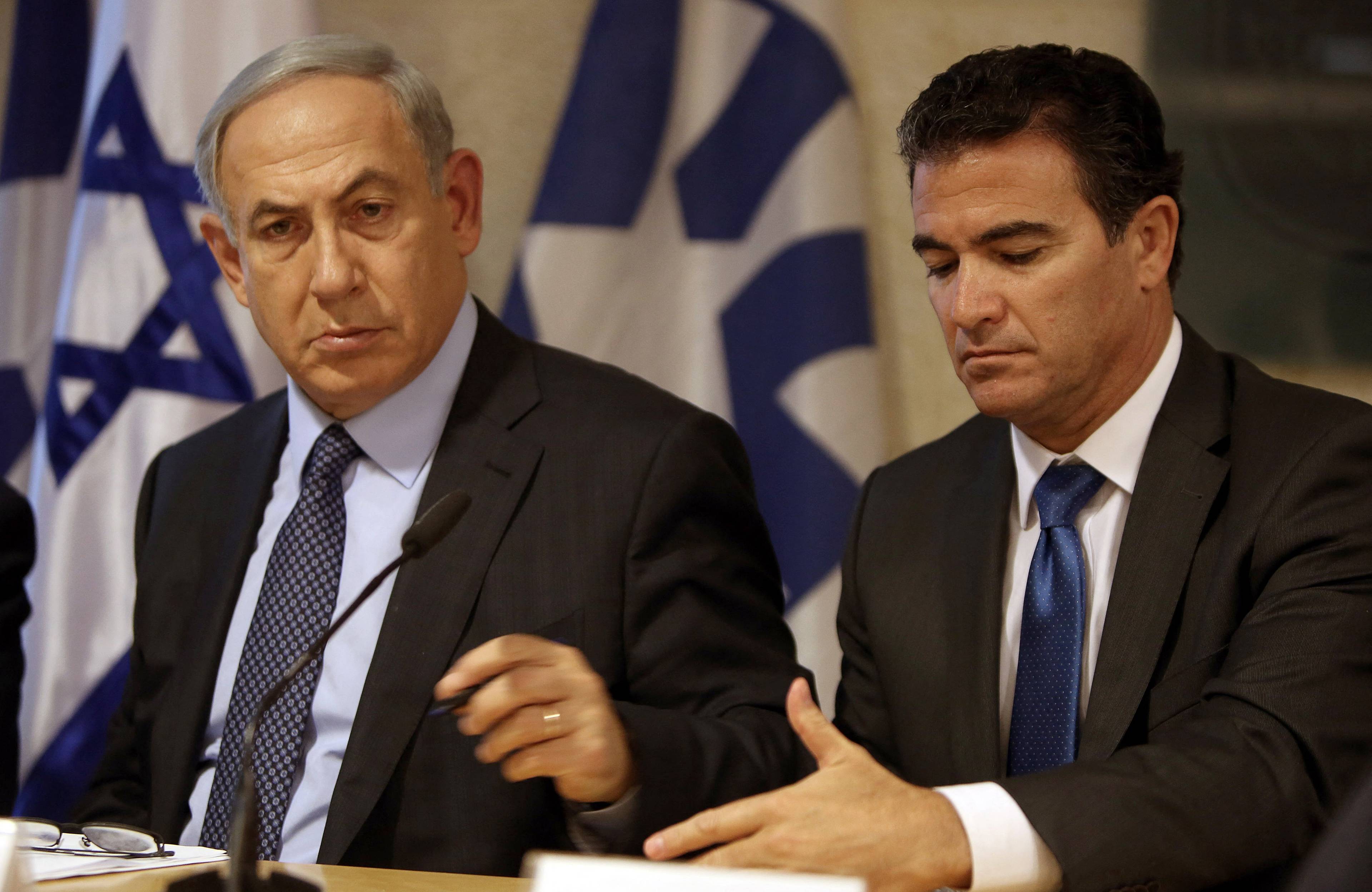 A file picture taken at the Israeli foreign ministry on October 15, 2015, shows Prime Minister Benjamin Netanyahu (L) sitting next to Yossi Cohen, who is currently the head of Israel's National Security Council, and who was named as the 12th head of the Mossad intelligence agency by Netanyahu on December 7, 2015. Cohen will take over from outgoing Mossad head Tamir Pardo, who will be leaving his post after five years next January. AFP PHOTO / GALI TIBBON (Photo by GALI TIBBON / AFP)