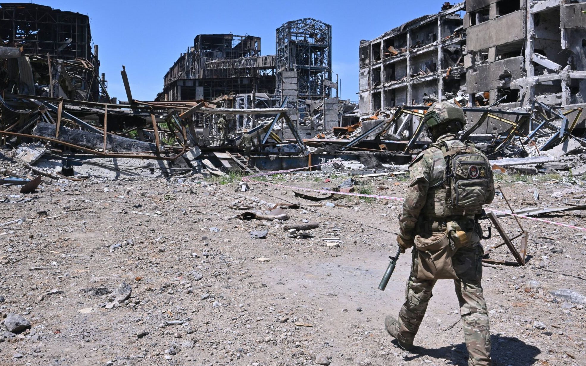 Russian serviceman patrols near the Azovstal steel plant in Mariupol, amid the ongoing Russian military action in Ukraine, on June 13, 2022. (Photo by Yuri KADOBNOV / AFP)