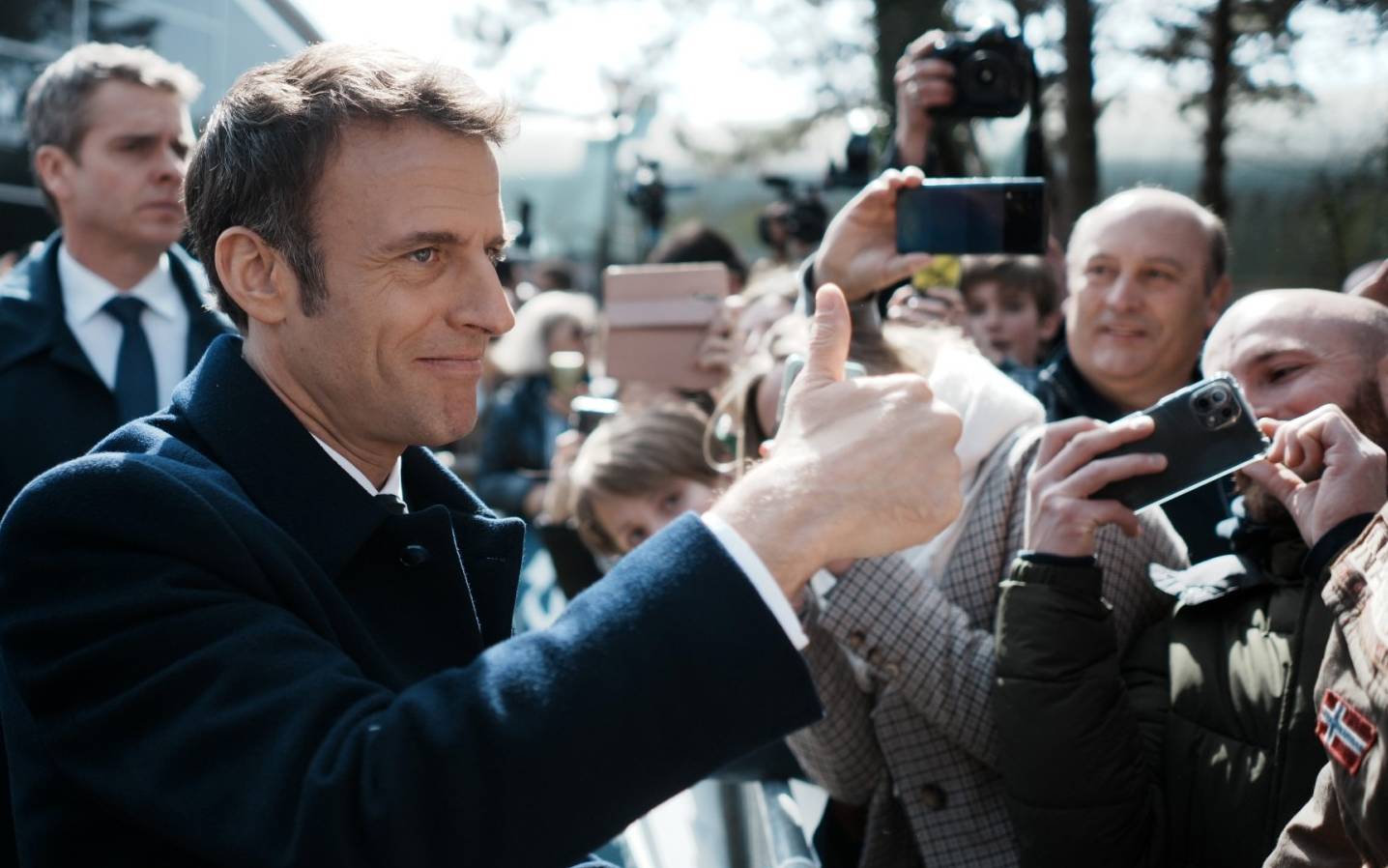 France's President and LREM party presidential candidate Emmanuel Macron thumbs up after voting for the first round of France's presidential election at a polling station in Le Touquet, northern France on April 10, 2022. (Photo by Thibault Camus / POOL / AFP)