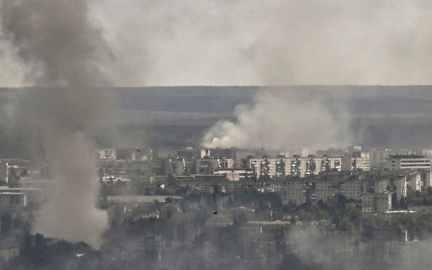 Smoke and dirt rise from shelling in the city of Severodonetsk during fight between Ukrainian and Russian troops in the eastern Ukrainian region of Donbas on June 7, 2022. (Photo by ARIS MESSINIS / AFP)